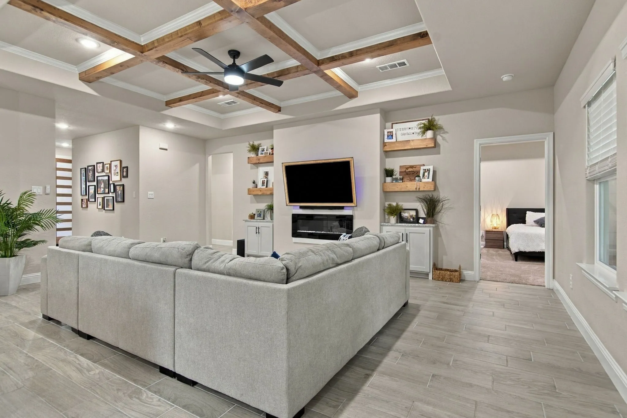 Tray ceiling with wood-finish beams and recessed lighting