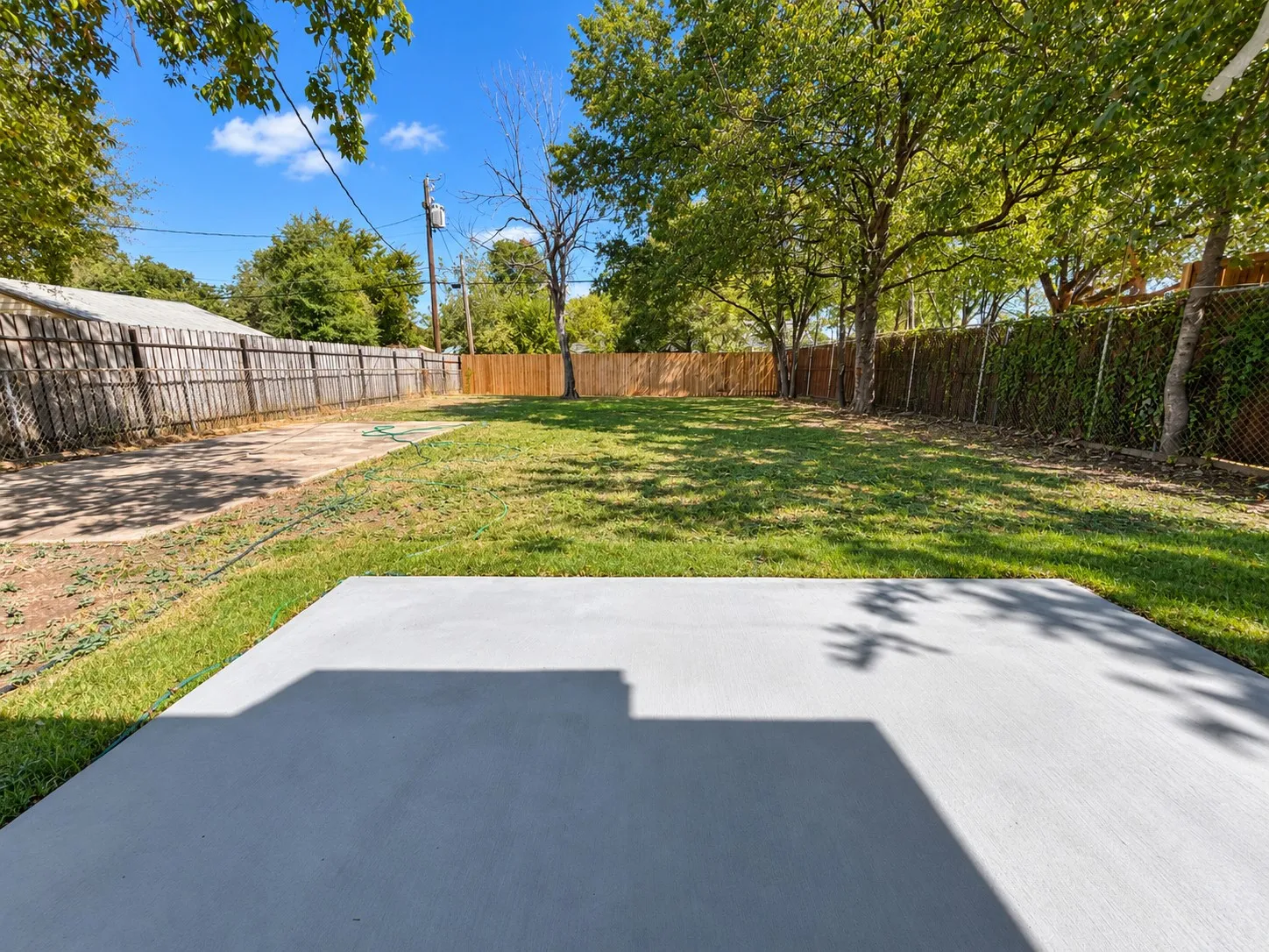View from patio - large yard with concrete pad and alley access for future addition or​​‌​​​​‌​​‌‌​‌‌​​​‌‌​‌​‌​‌​​​‌​​ garage