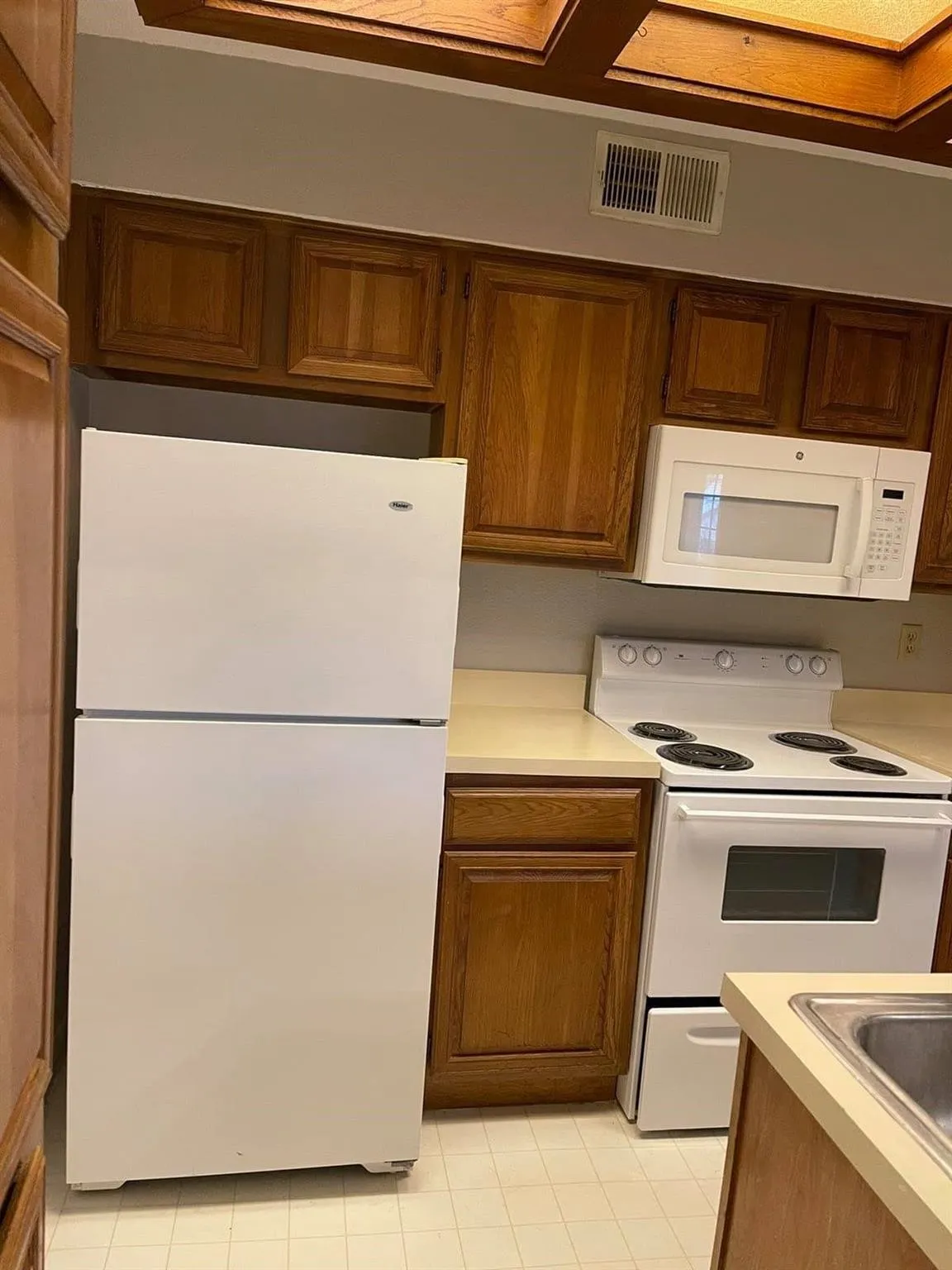 Wood-finish cabinetry paired with light-toned countertops