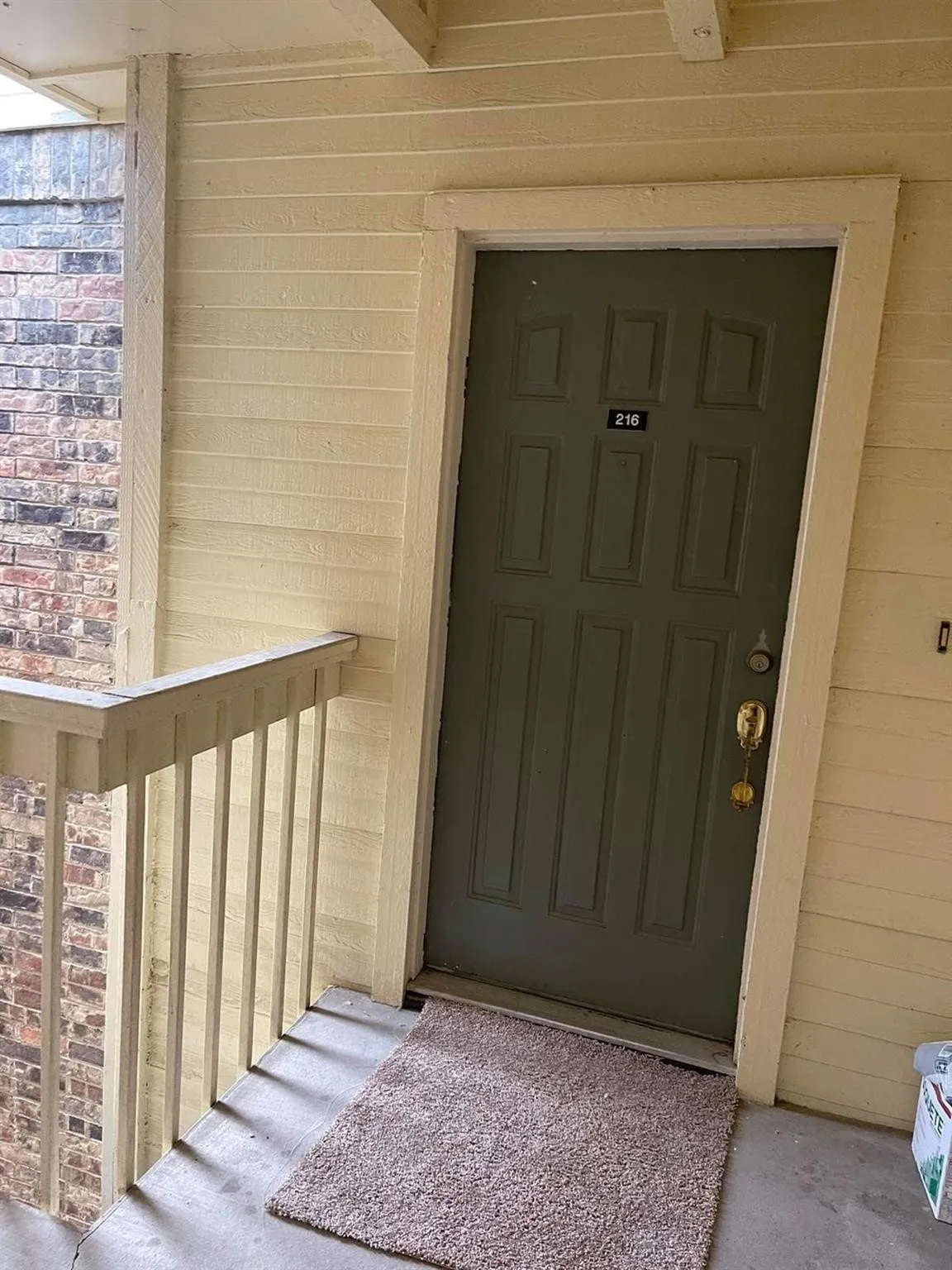 Panel door with decorative molding and brass-finish hardware