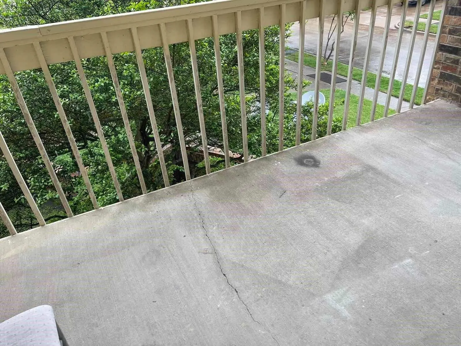 Balcony with a metal railing and concrete flooring