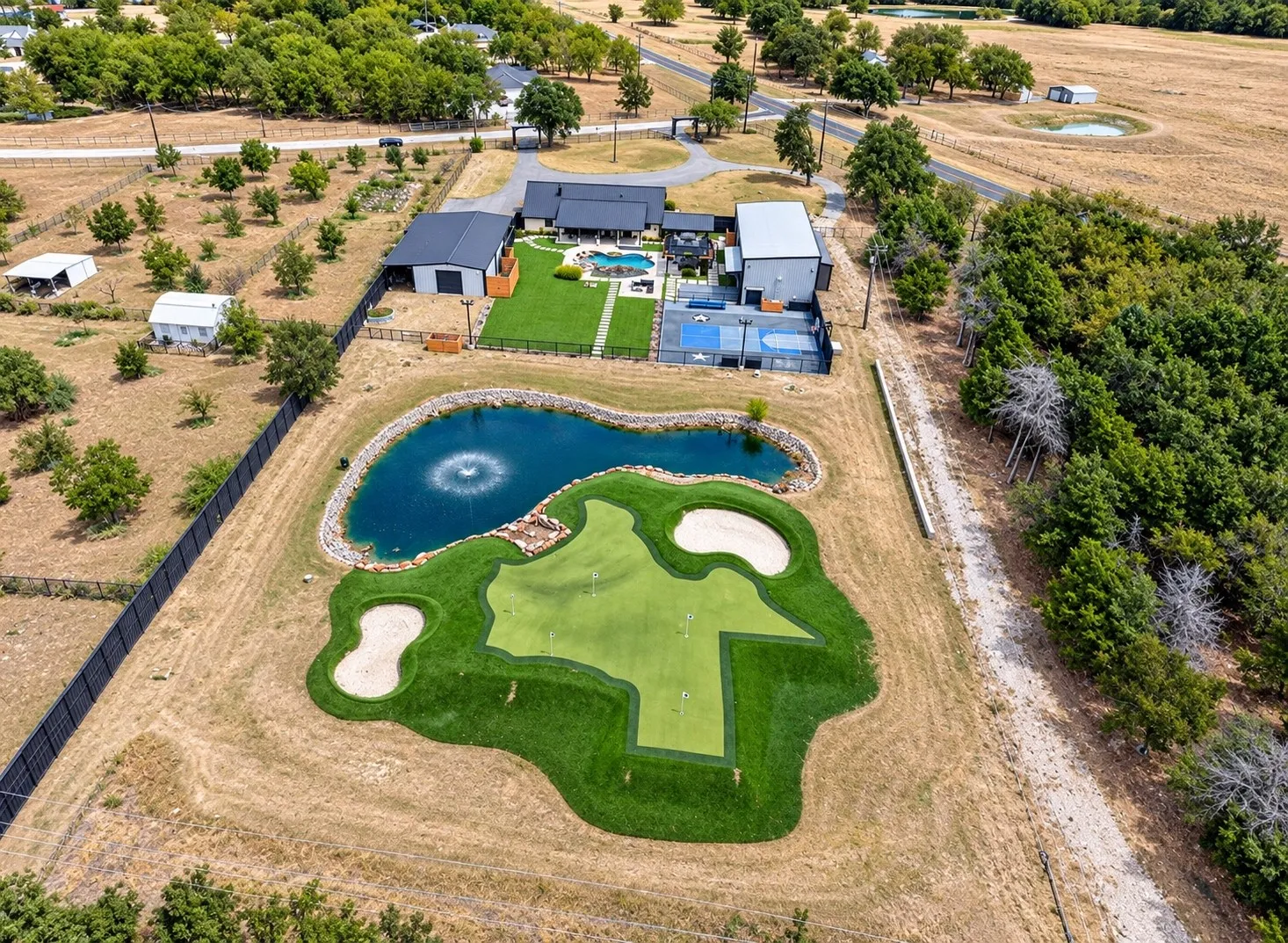 Aerial view from the rear of the property showing the Texas shaped putting green