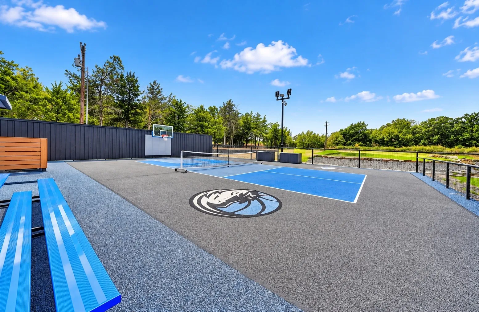 Pickleball/basketball court with bleachers