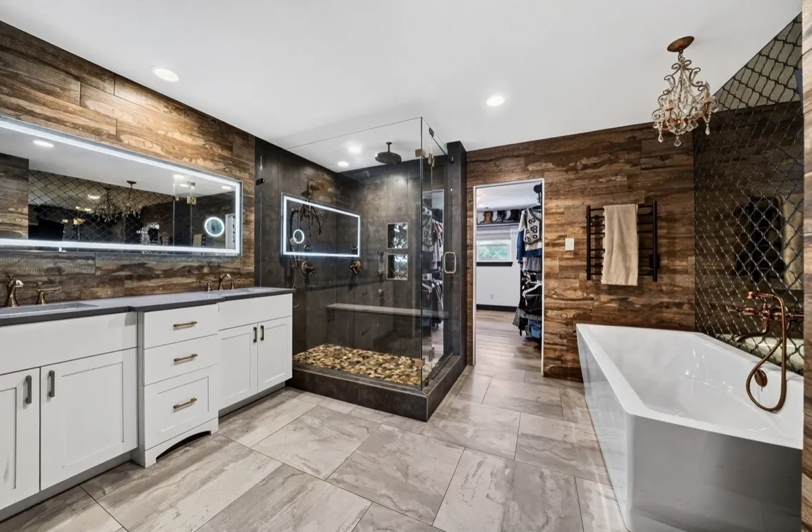 Primary bathroom with two large sized walk-in closets