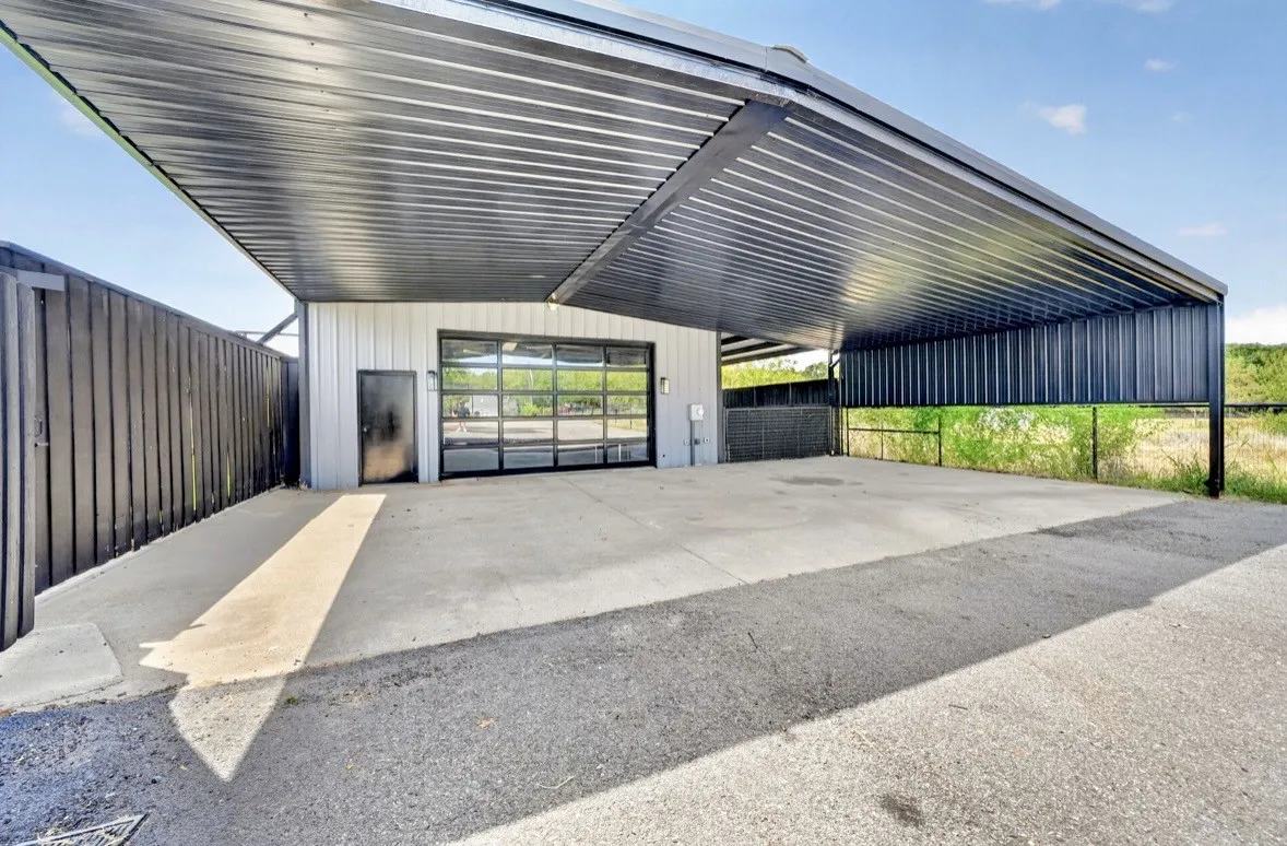 Garage with additional covered parking and RV storage area