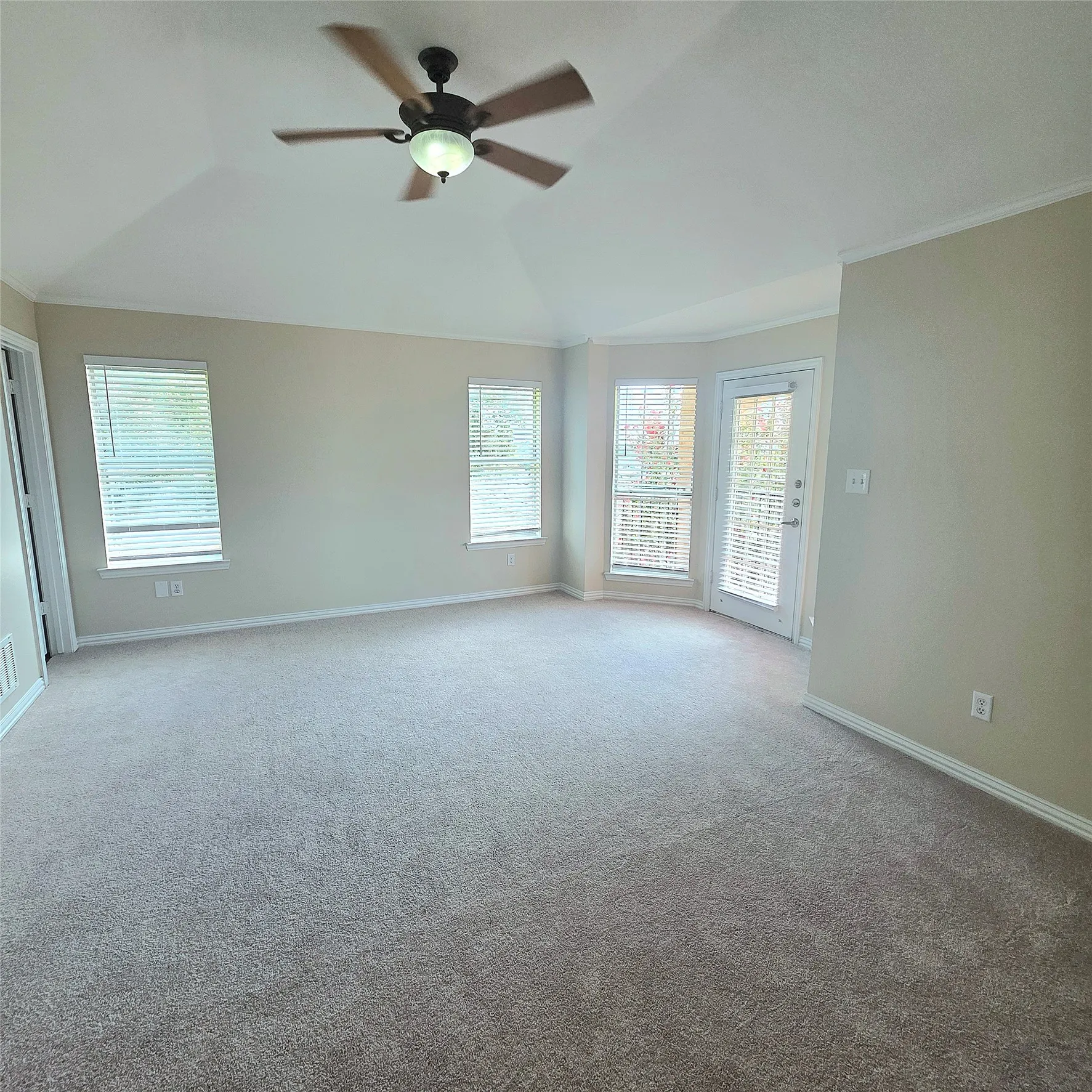 View glorious sunsets and glimpses of Lake Ray Hubbard from this  spacious upper level primary suite featuring aTrey ceiling, crown molding,  crisp woodlook blinds.  new carpet and bay windows with a door out to a covered balcony.