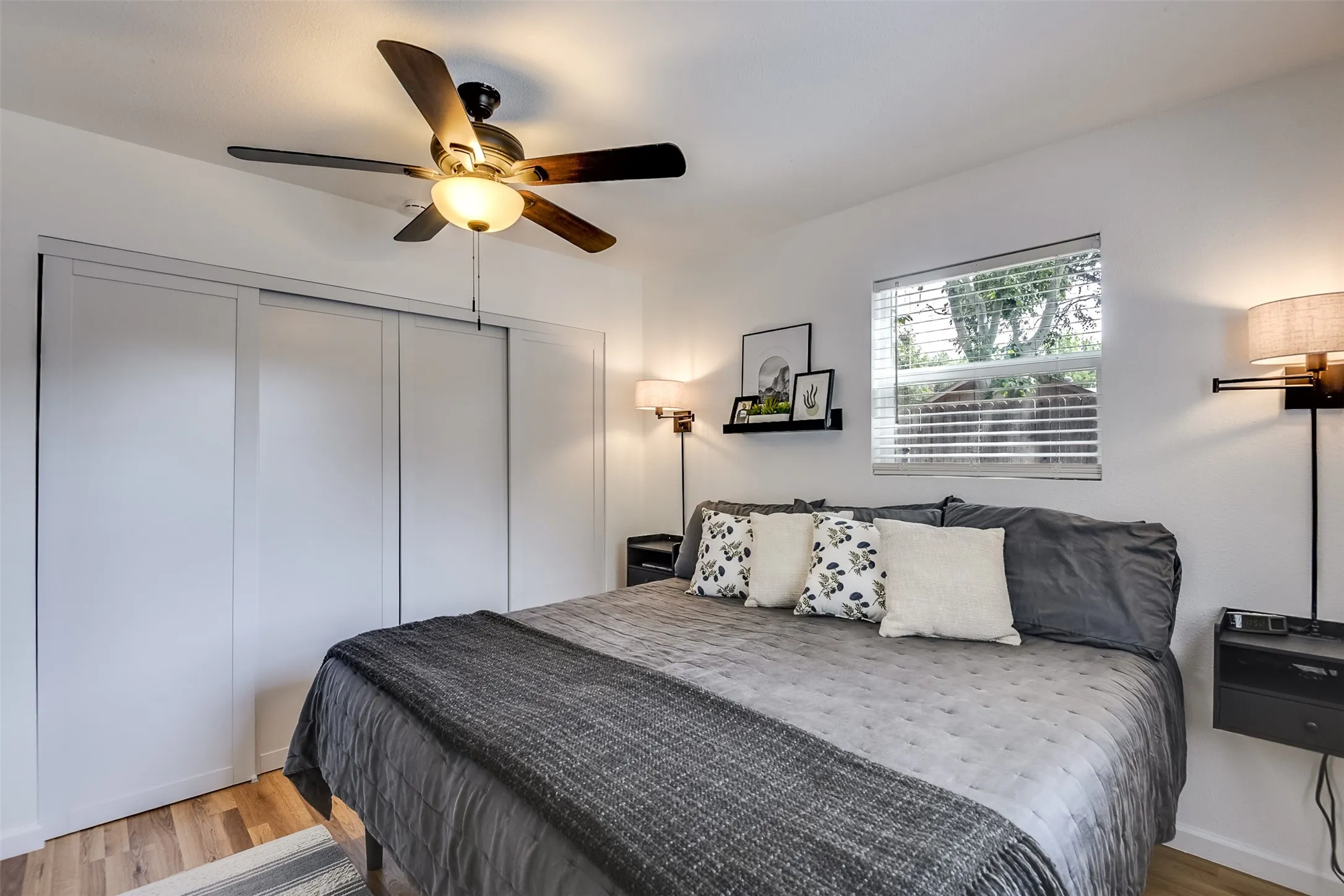 This bedroom comfortably accommodates a king-sized bed.  Stylish hanging nightstands and light fixtures remain with the property.