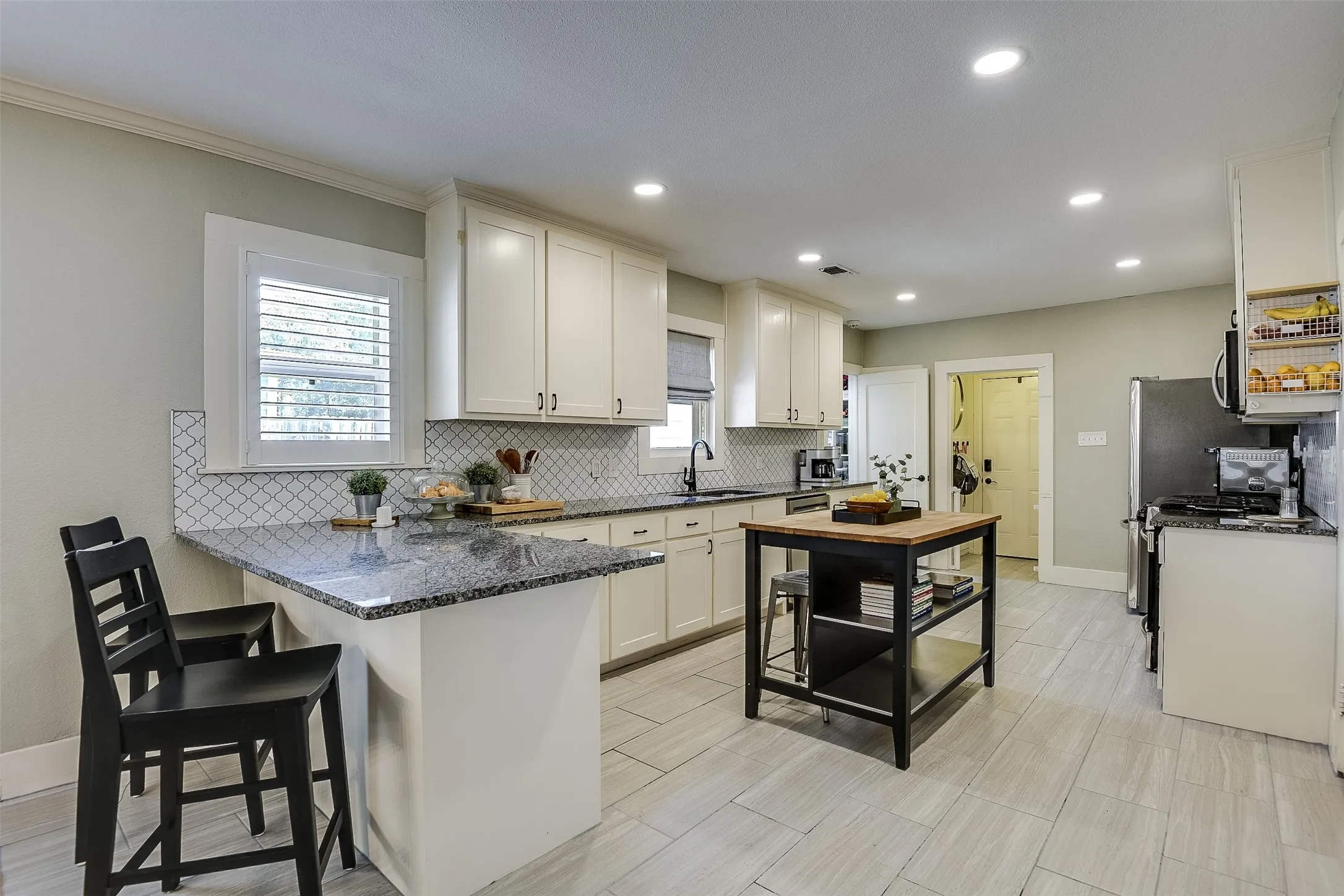 Generously proportioned cook-friendly kitchen connects to the informal dining room making this your home's centerpiece.  The extension of the counter space forms a serving/dining bar.  What a great spot to relax and recount the day's activities with the resident chef.