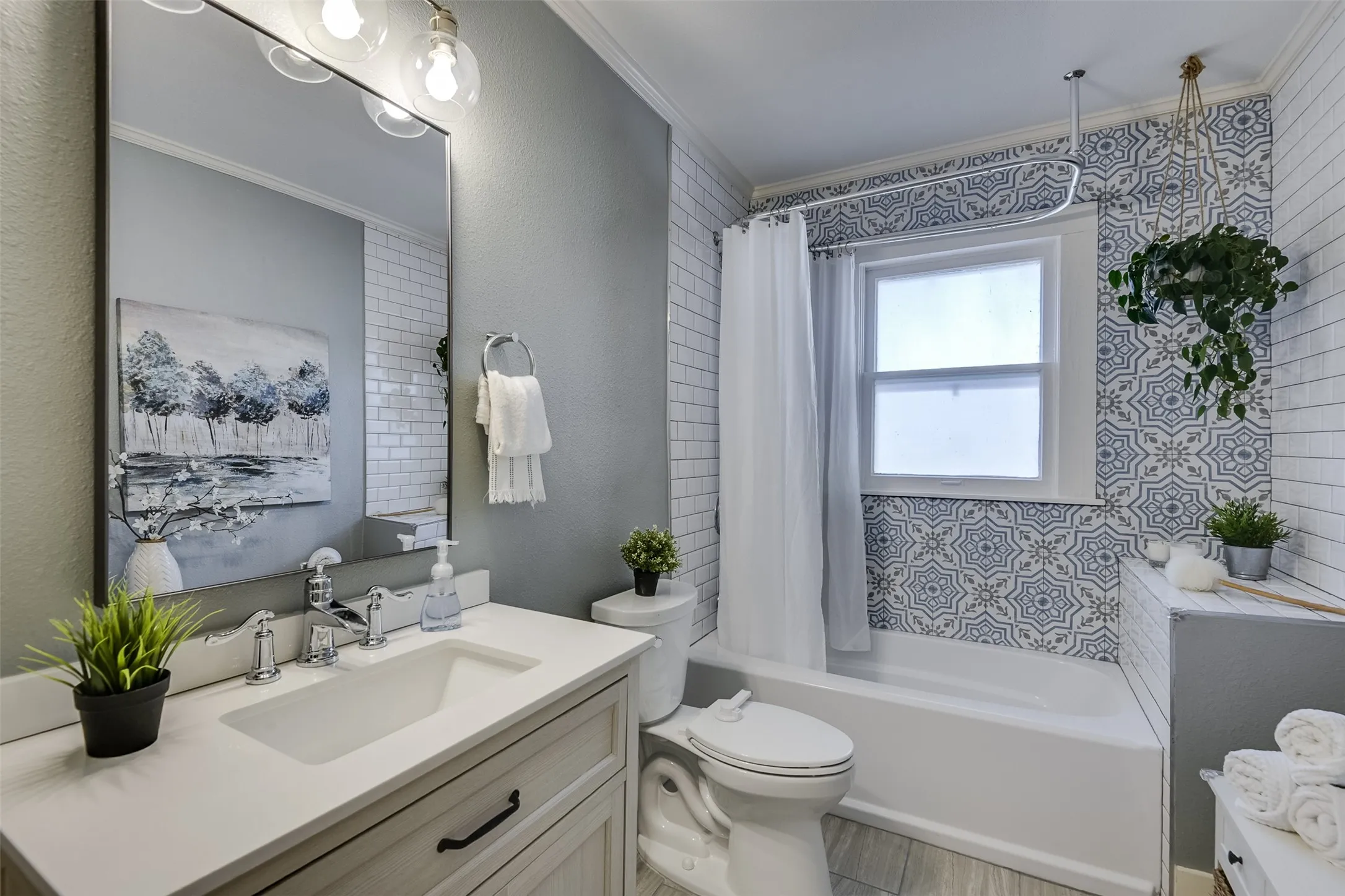 Oversized secondary bath with plenty of storage boasts a total update delivering plenty of personality.  A playful retro-inspired shower treatment adds a distinctive touch, paying homage to the home's original design elements while giving this bath a fun sense of character.