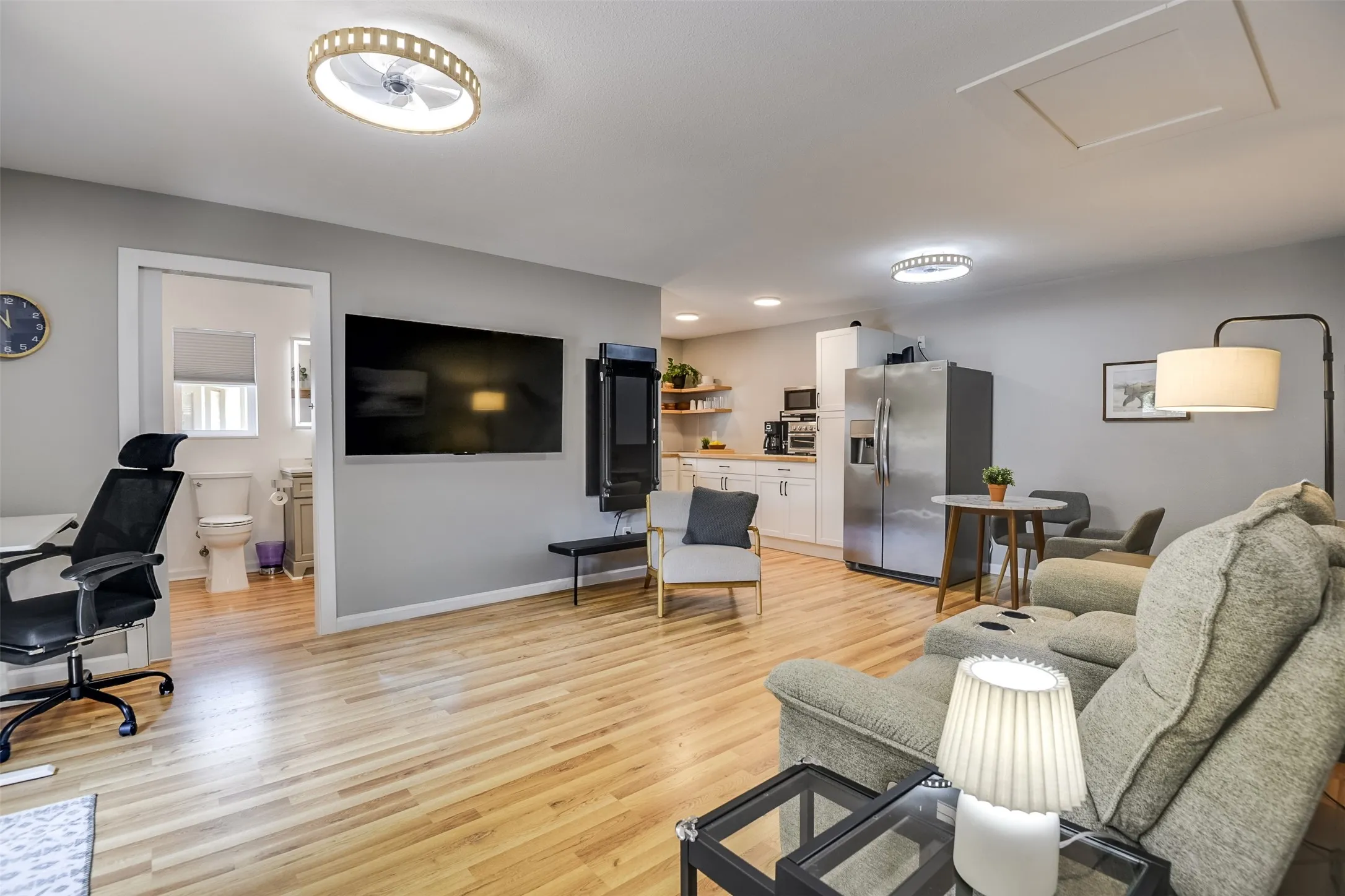Classic and understated, the reverse view reveals a convenient kitchen paired with a space for dining.  Imagine the ultimate man cave - fire up the games, set up the pool table and settle in with friends.  The Tonal workout machine has been removed.