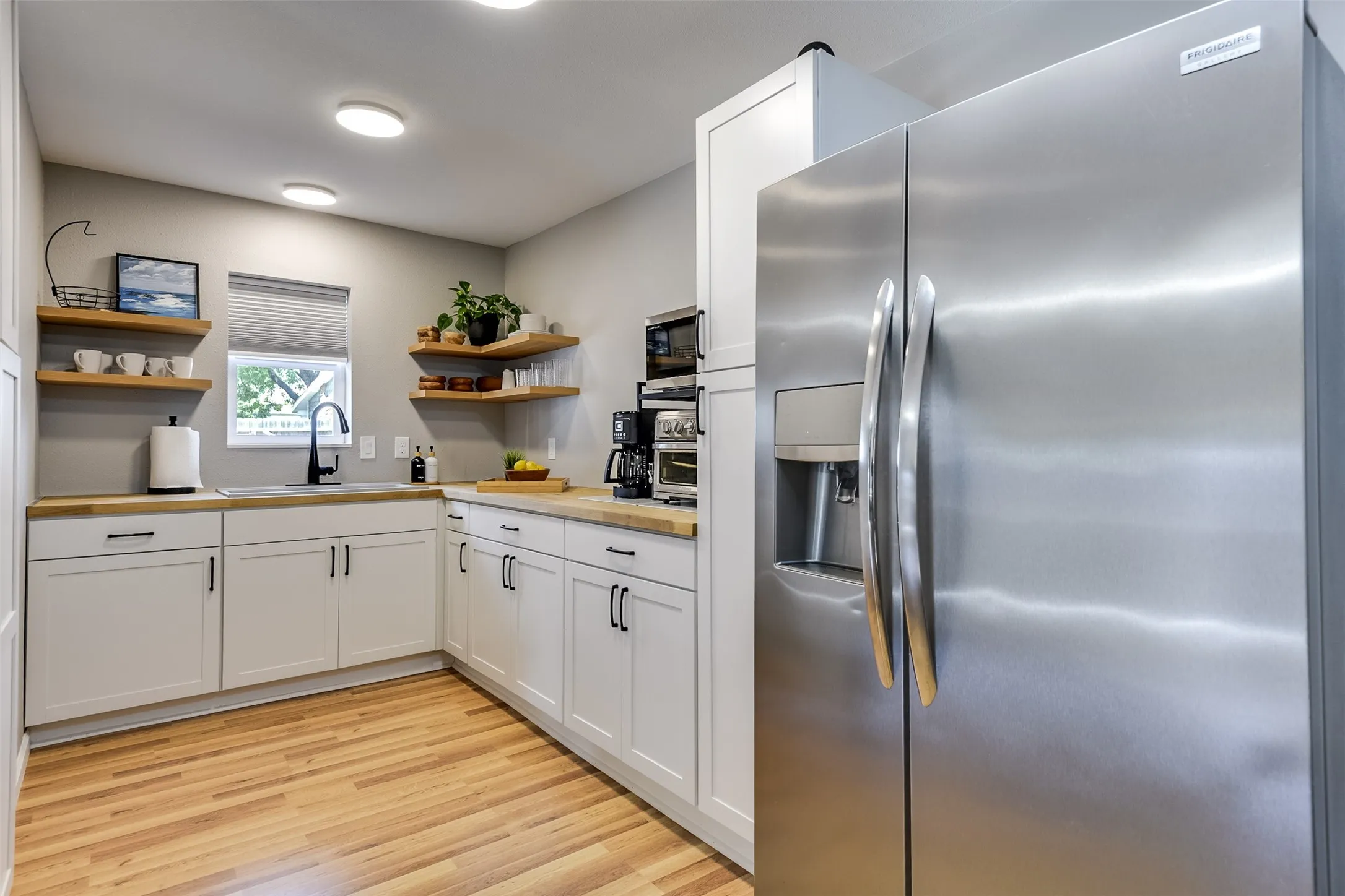 Thoughtfully appointed for both style and function, this well-designed kitchen delivers everything you need in a smart, efficient layout.  The toaster oven and microwave are included and remain with the house.