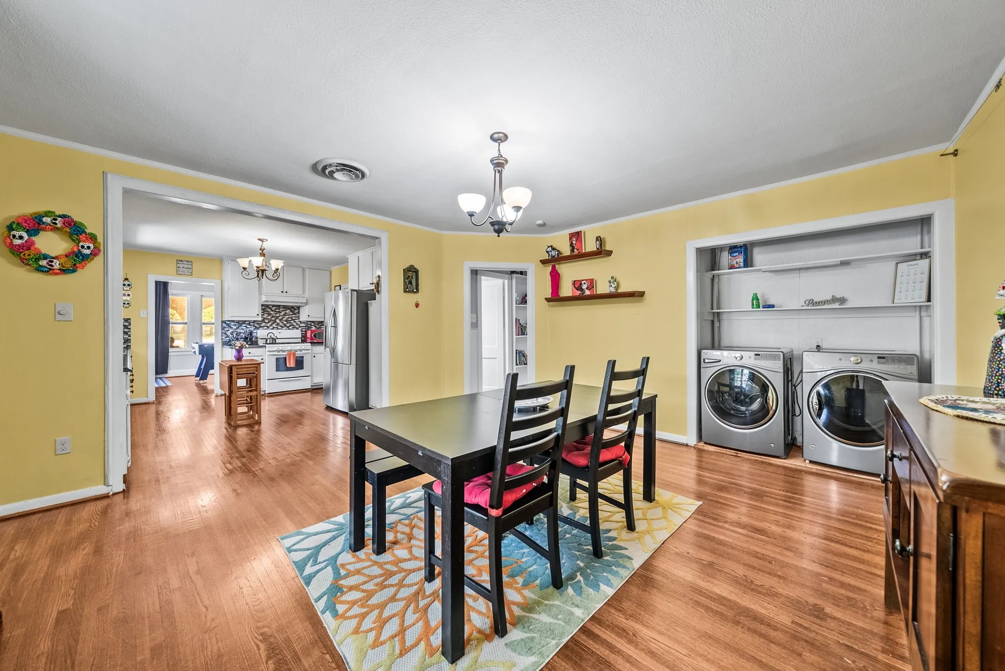 Hardwood-finish flooring throughout, with a recessed laundry area featuring shelving