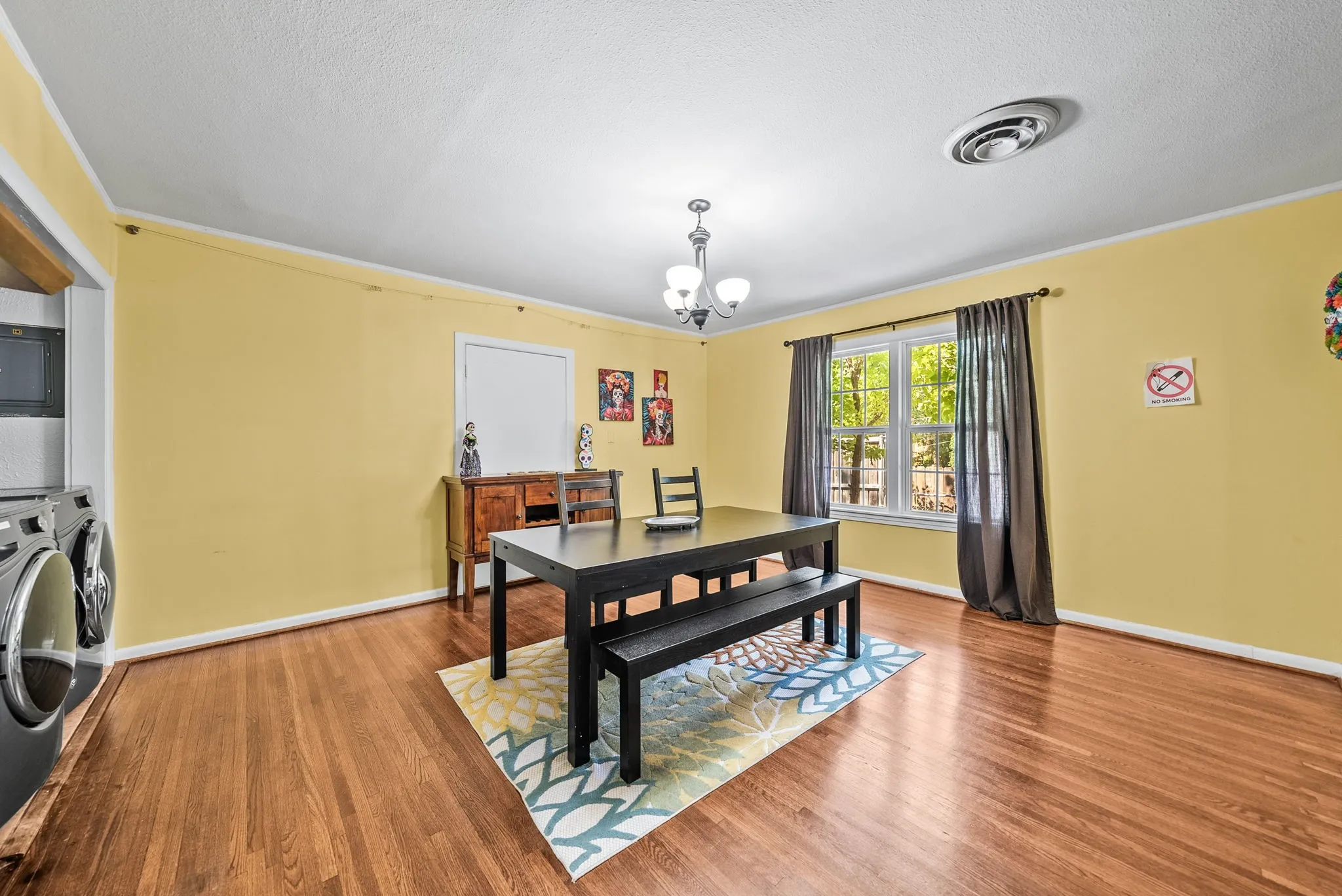 Hardwood flooring extending throughout, window with natural light, and overhead lighting
