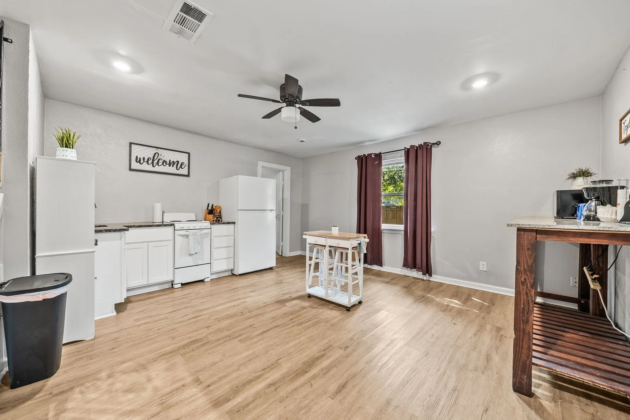Wood-finish flooring throughout, recessed lighting, and a ceiling fan