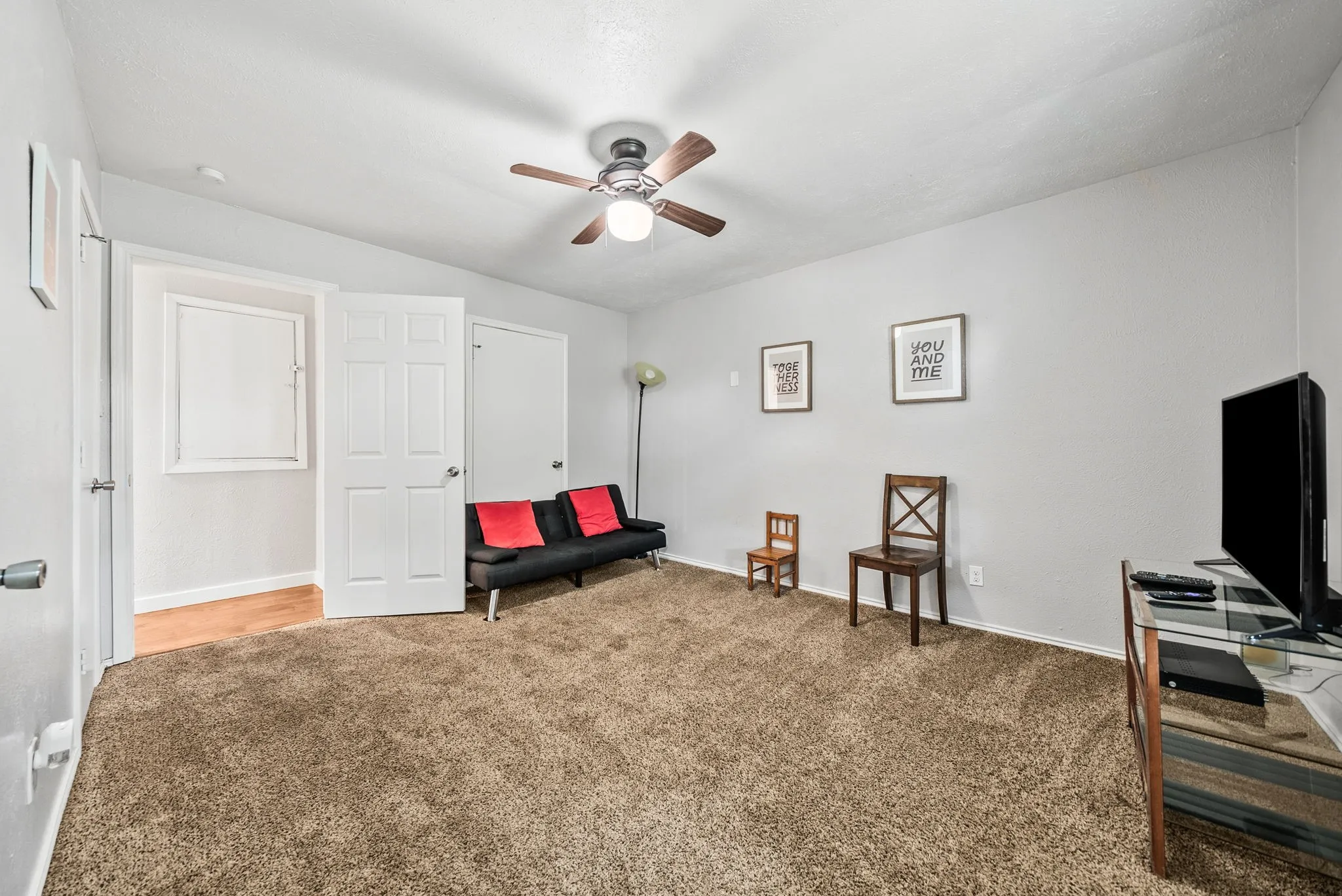 Carpeted room with light grey walls, a ceiling fan, and white trim work