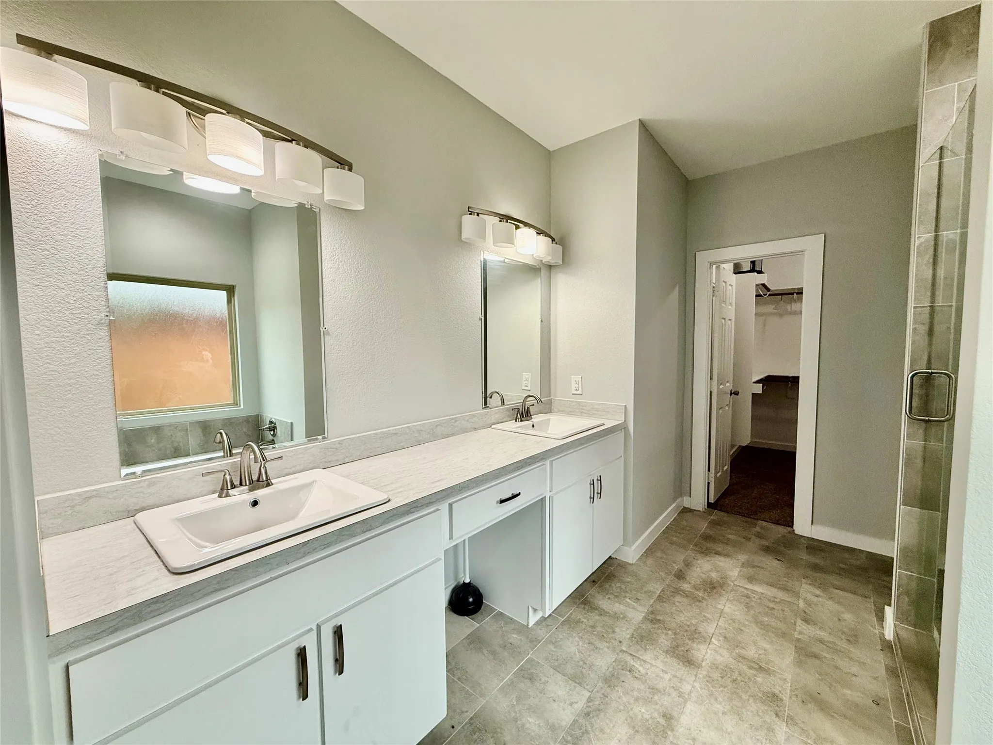 Dual vanity with integrated sinks and brushed nickel fixtures