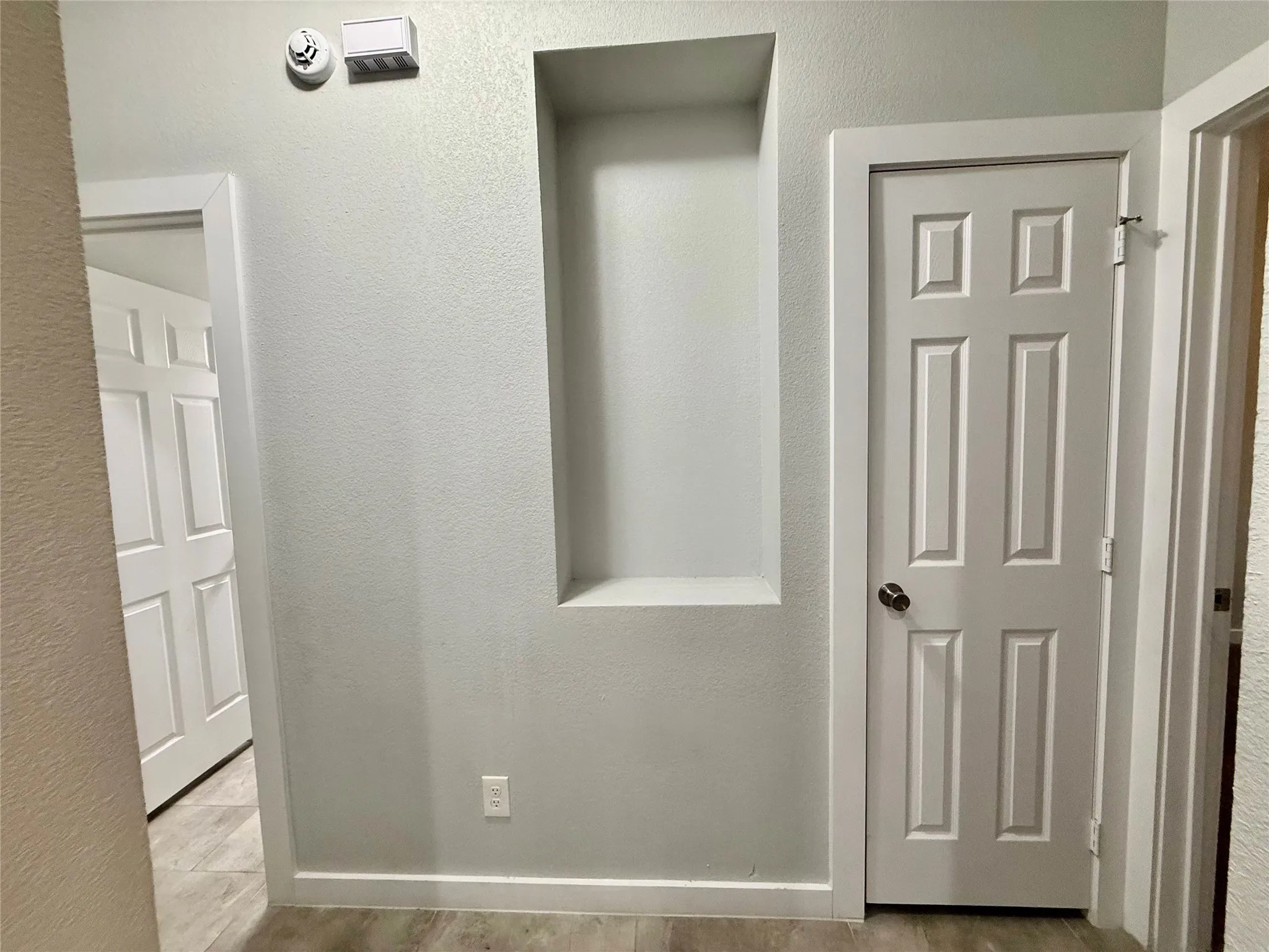 Built-in wall niche with light-toned wall finish