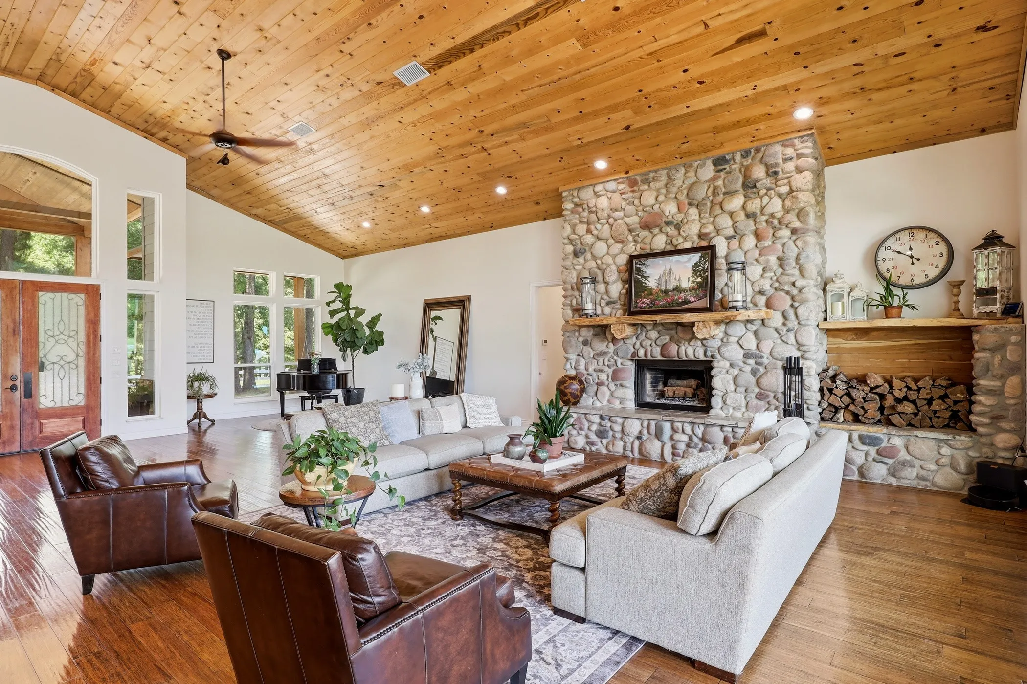Vaulted wood-paneled ceiling with recessed lighting and a ceiling fan