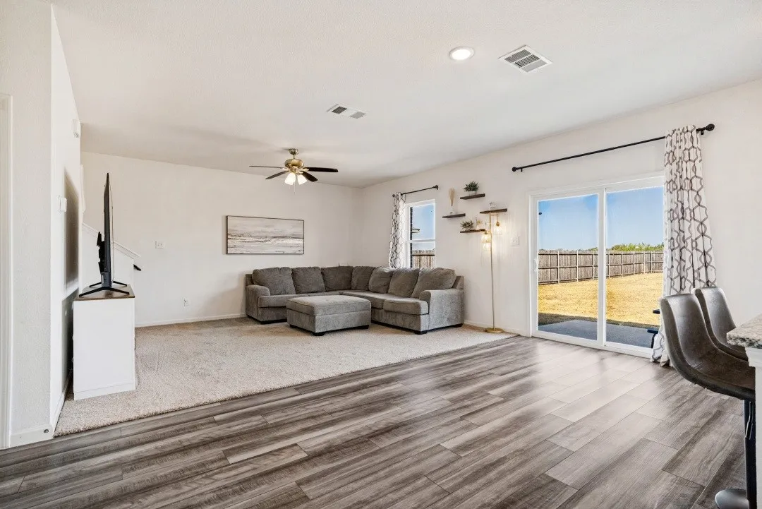 Wood-finish flooring, recessed lighting, and a ceiling fan