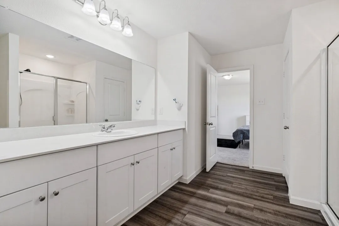 Double vanity with white cabinetry and integrated sink