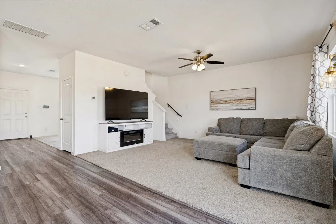 Open-concept living area featuring wood-finish flooring, recessed lighting, and a ceiling fan