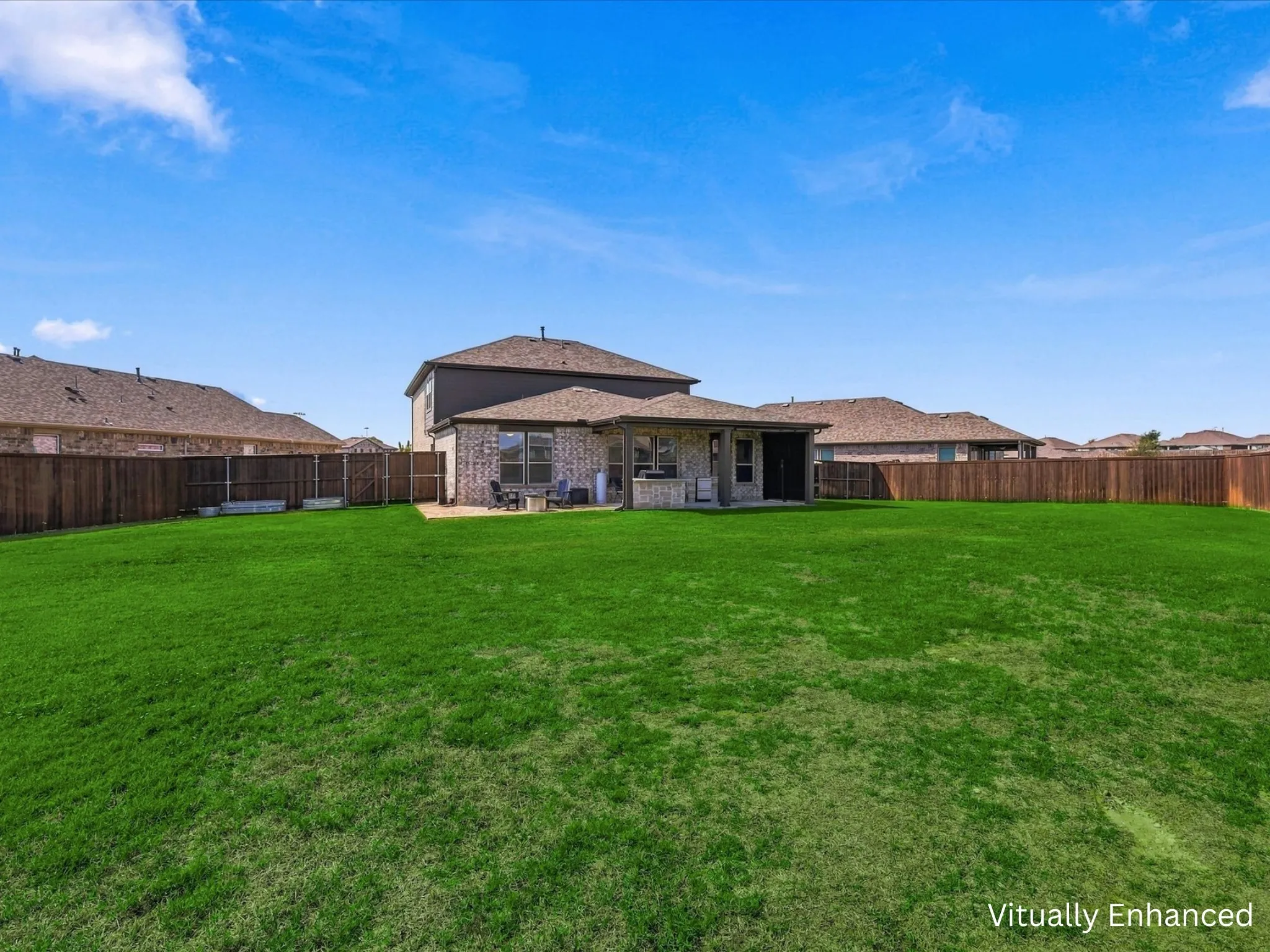 Oversized backyard showing back patio entertaining area.