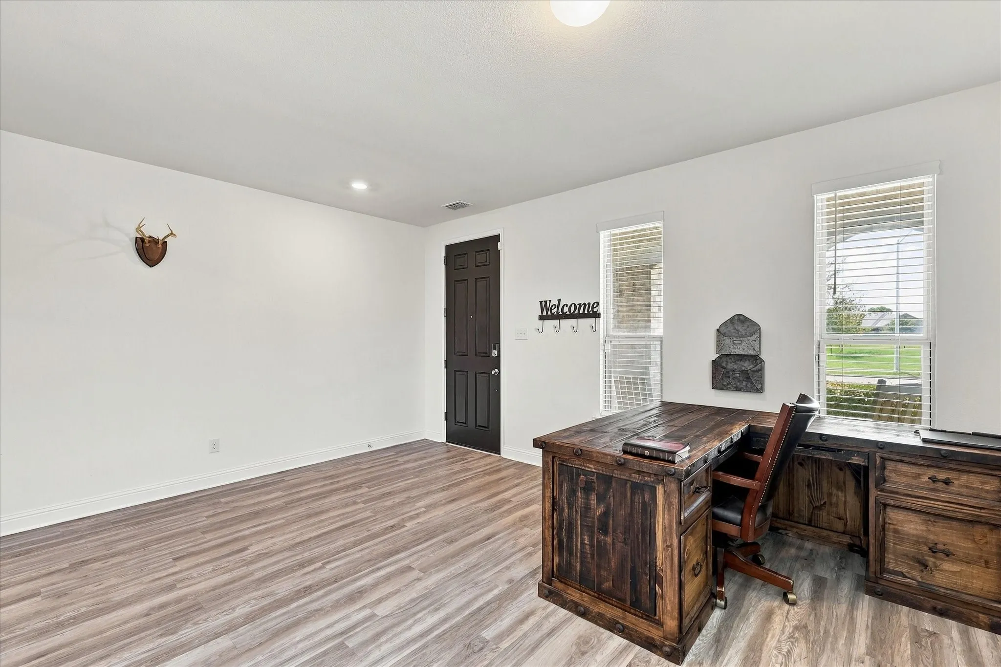 Front room currently being used as an office, but could be a dining area, second living room, or many other options.