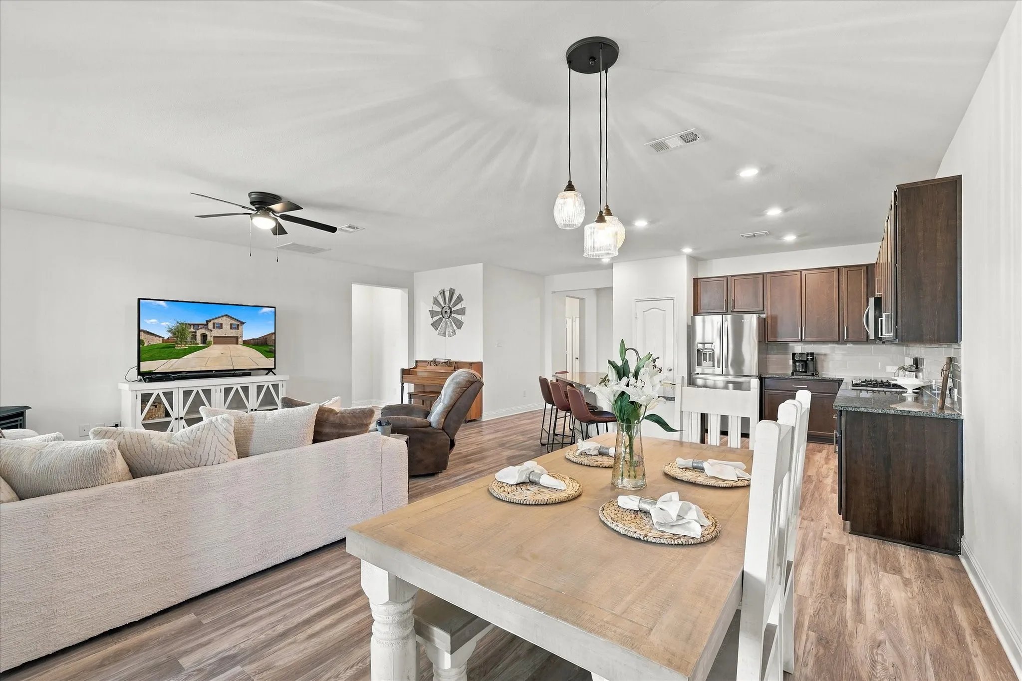 Large open area with dining room, living room, and kitchen with oversized island which provides a lot of additional seating