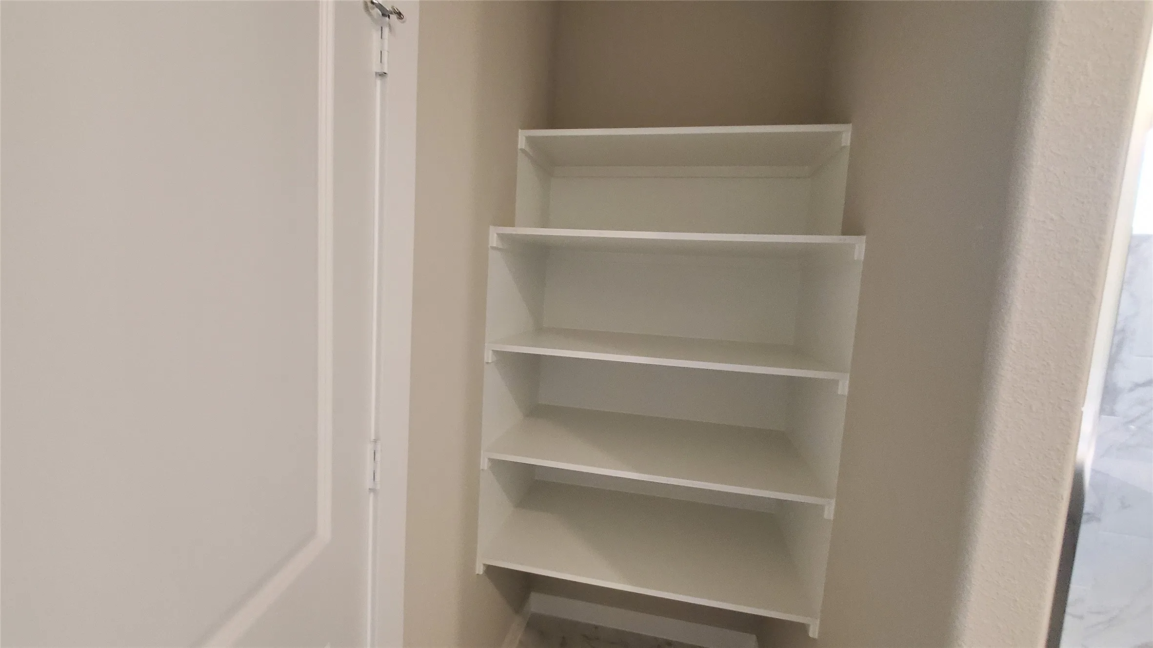 Built-in shelving with five white shelves