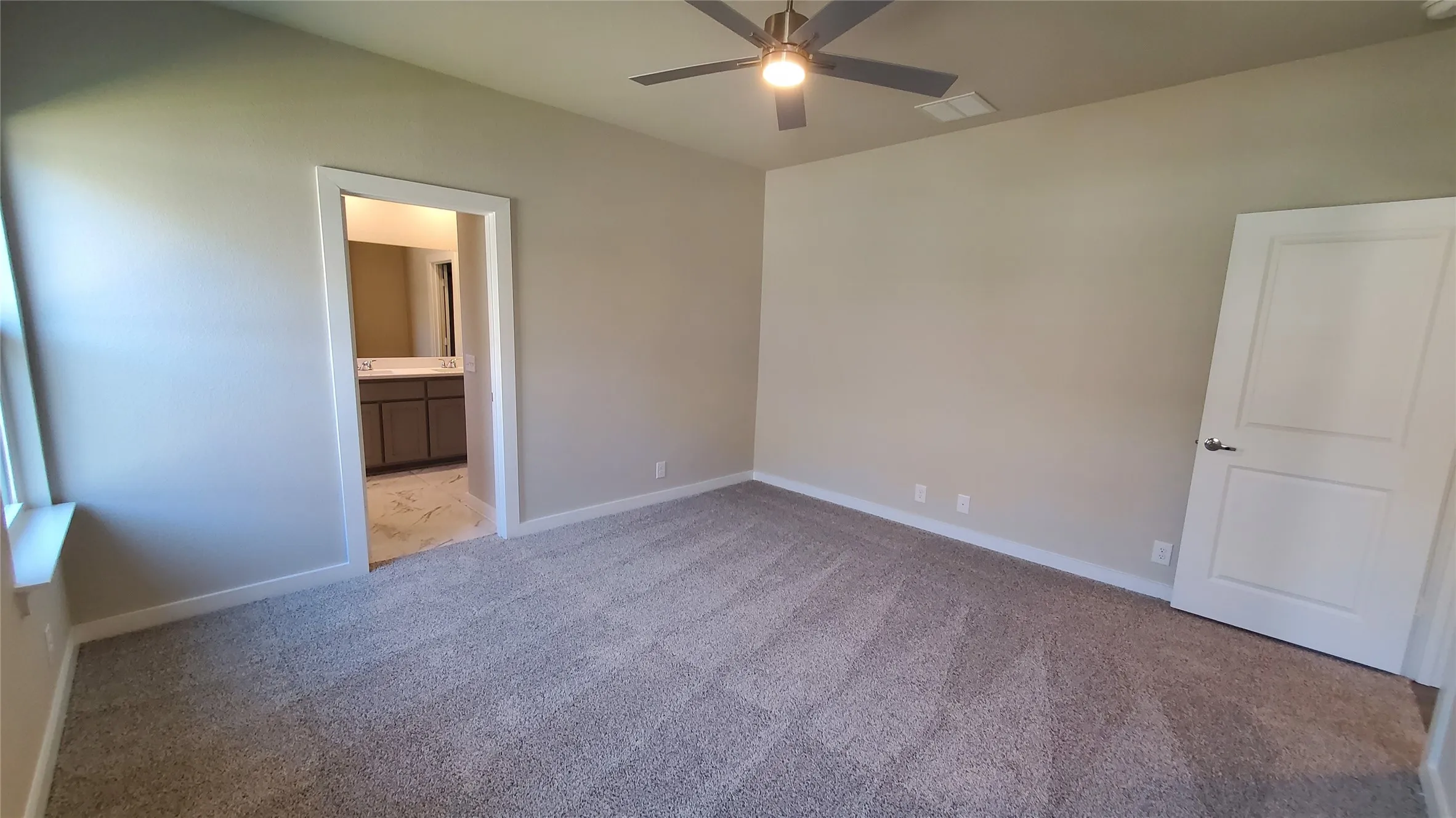 Carpeted flooring, ceiling fan with integrated lighting, a white panel door, and neutral-toned walls