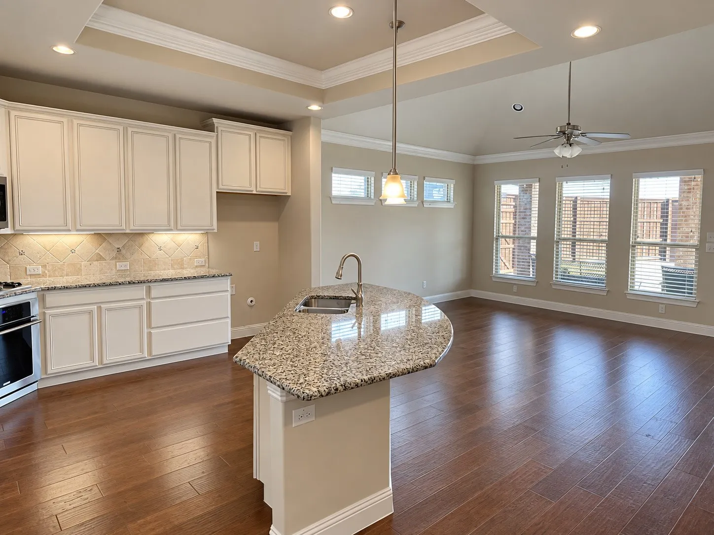 Open-concept living space with wood-finish flooring