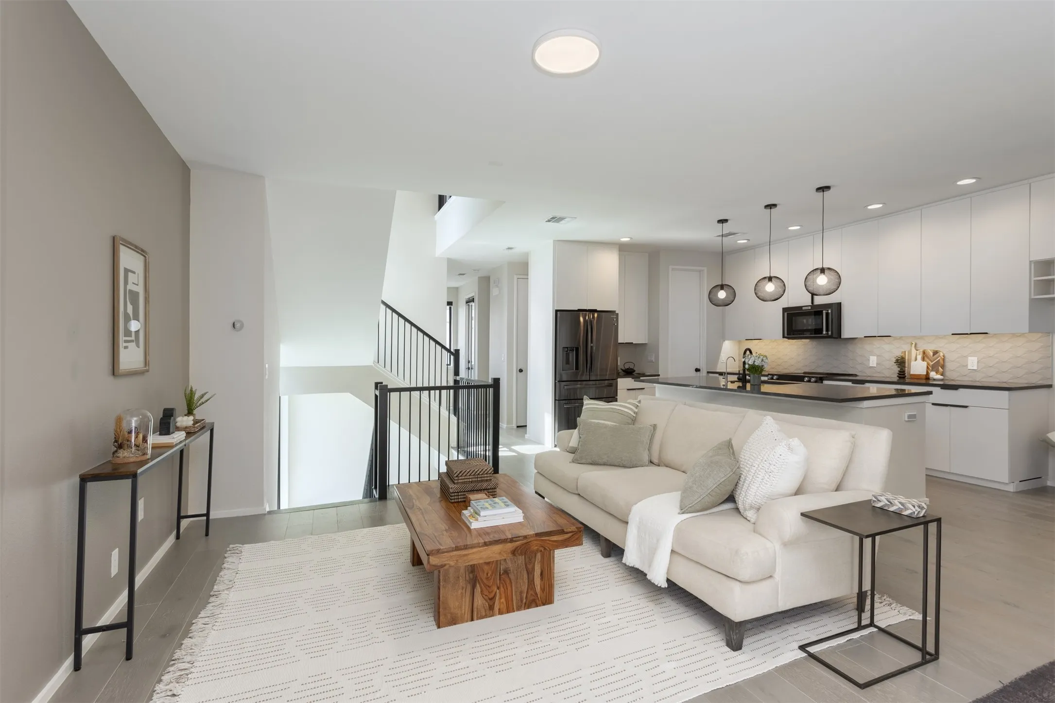 Living room featuring stairway and light wood-style floors