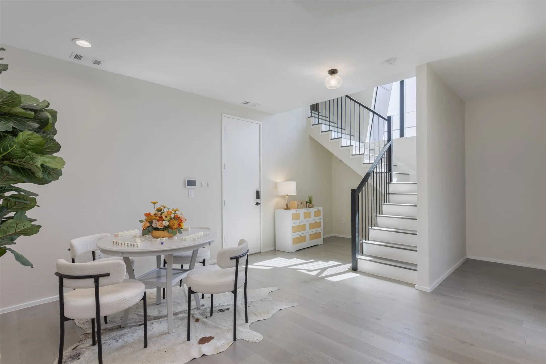 Dining room featuring stairway and light wood-style flooring