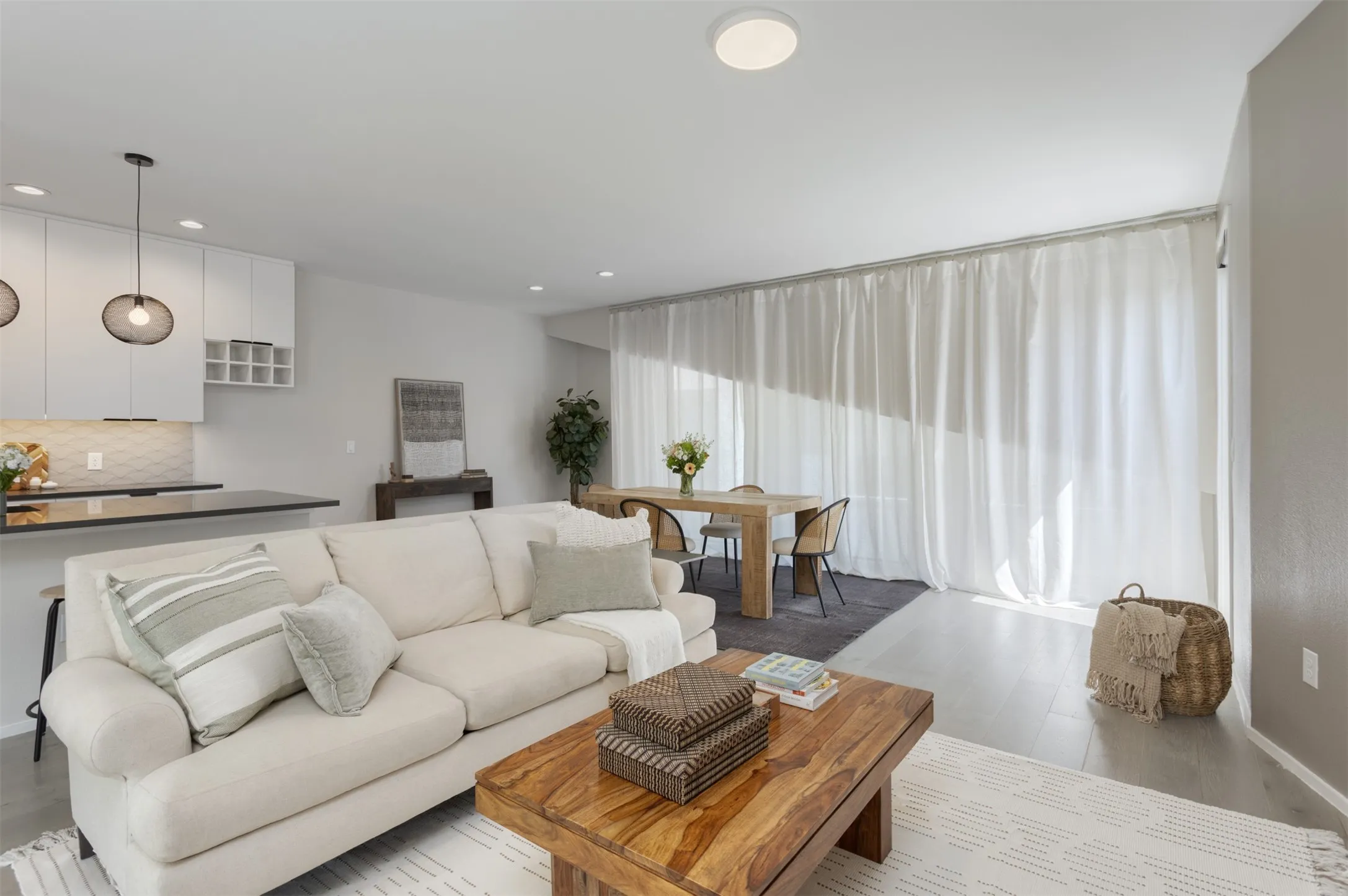 Living area with light wood finished floors and baseboards
