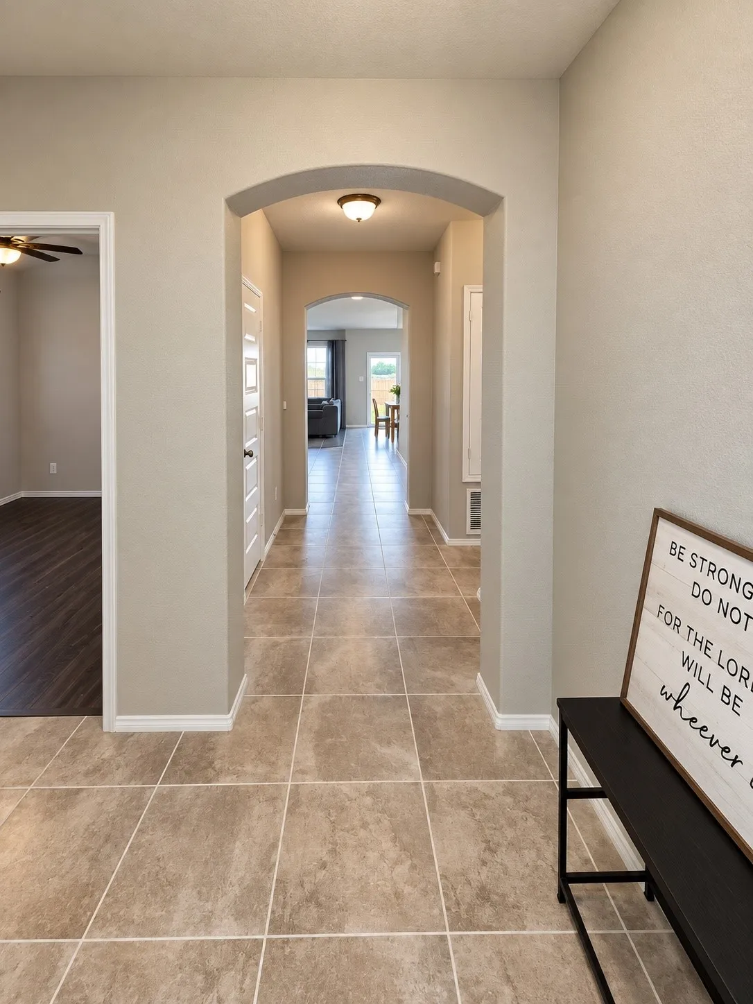 Arched entryway featuring tile flooring and neutral wall tones