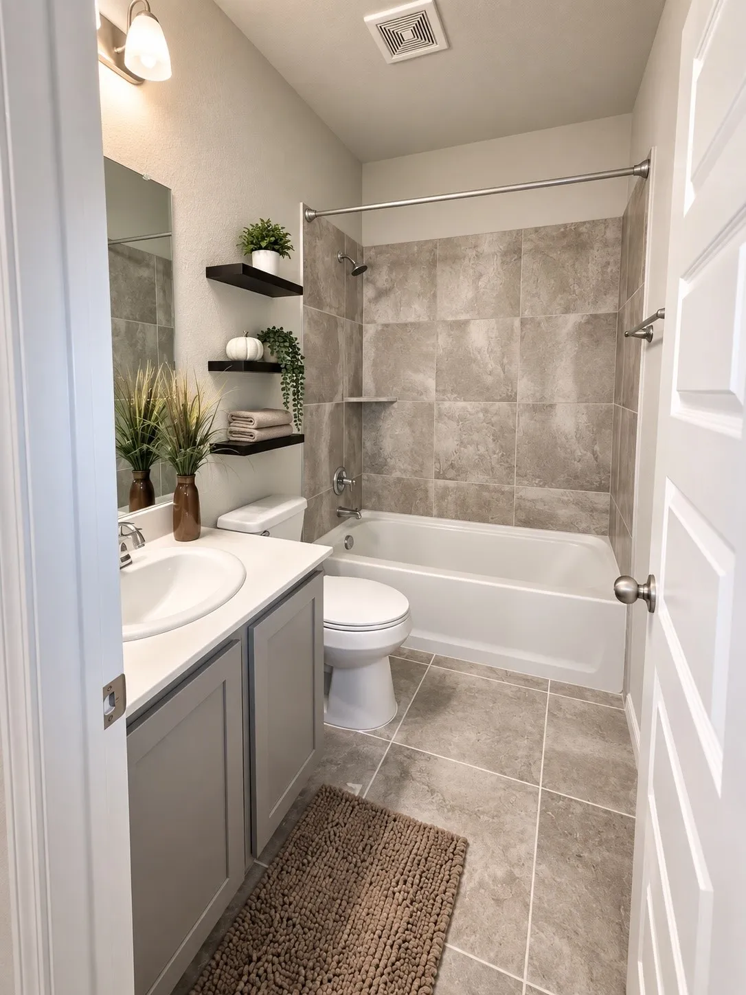 Full bathroom featuring a single vanity with under-sink cabinetry, a full-size bathtub with subway tile surround, floating shelves, and tile flooring