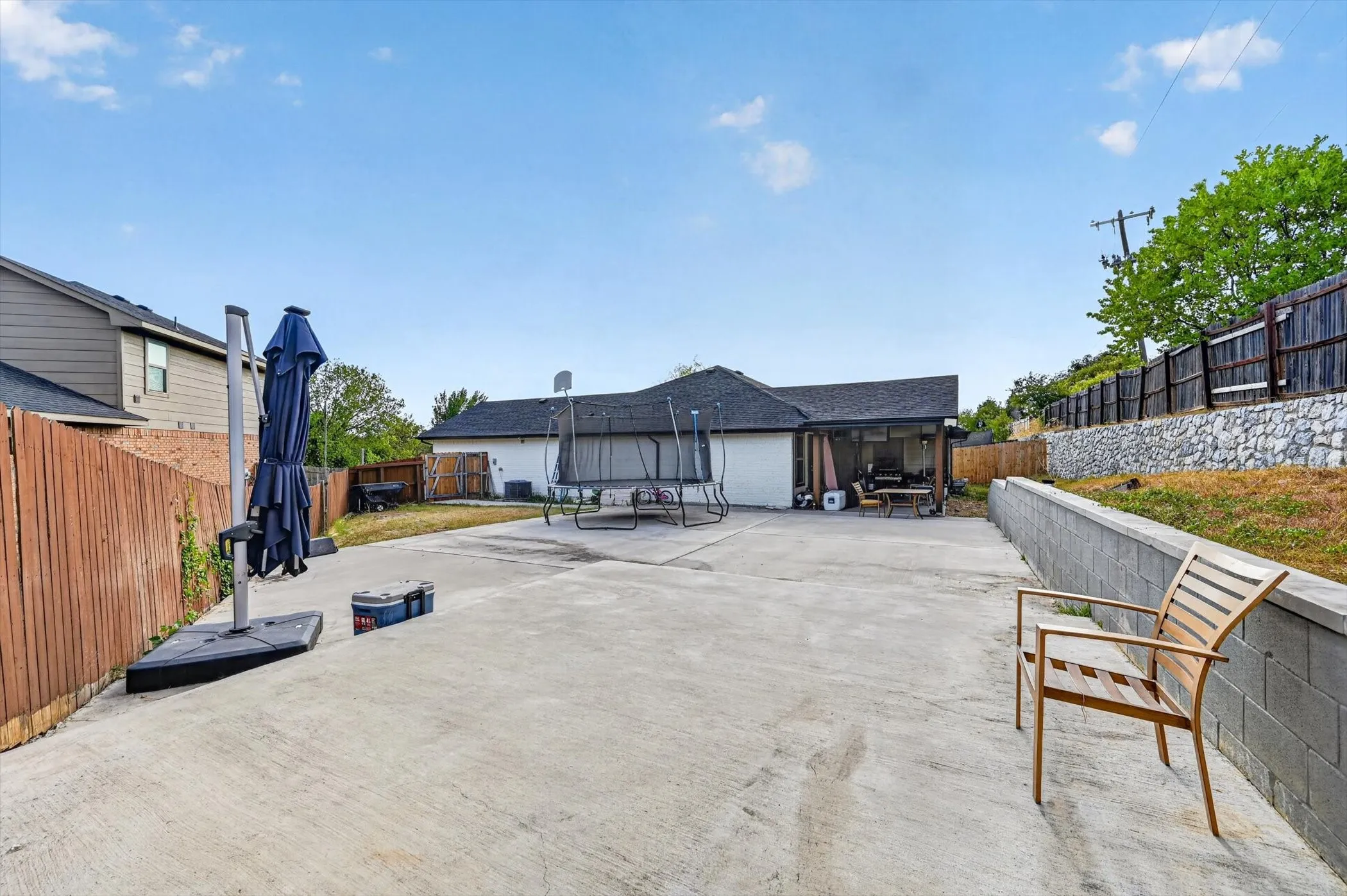 Spacious concrete patio with an attached covered outdoor area