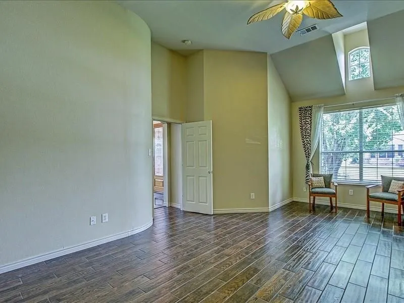 Vaulted ceilings, wood-finish flooring, and arched windows