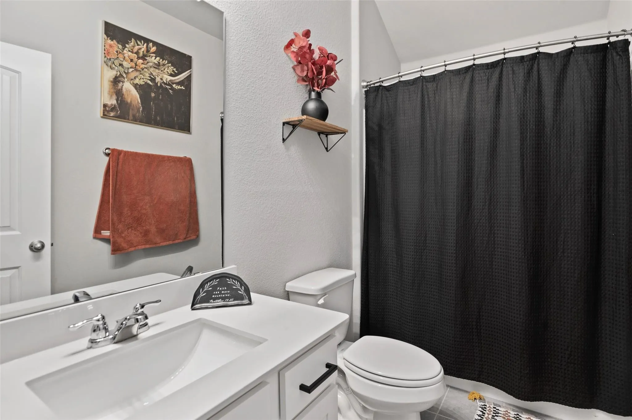 White vanity with an integrated rectangular sink and chrome faucet