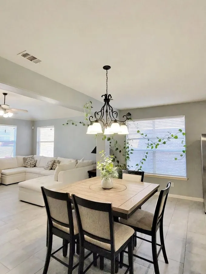 Recessed lighting, wood-finish flooring, and a decorative chandelier