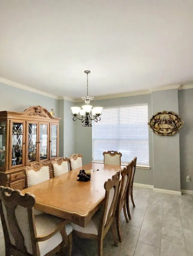 Recessed lighting, crown molding, a window with horizontal blinds, and tile flooring