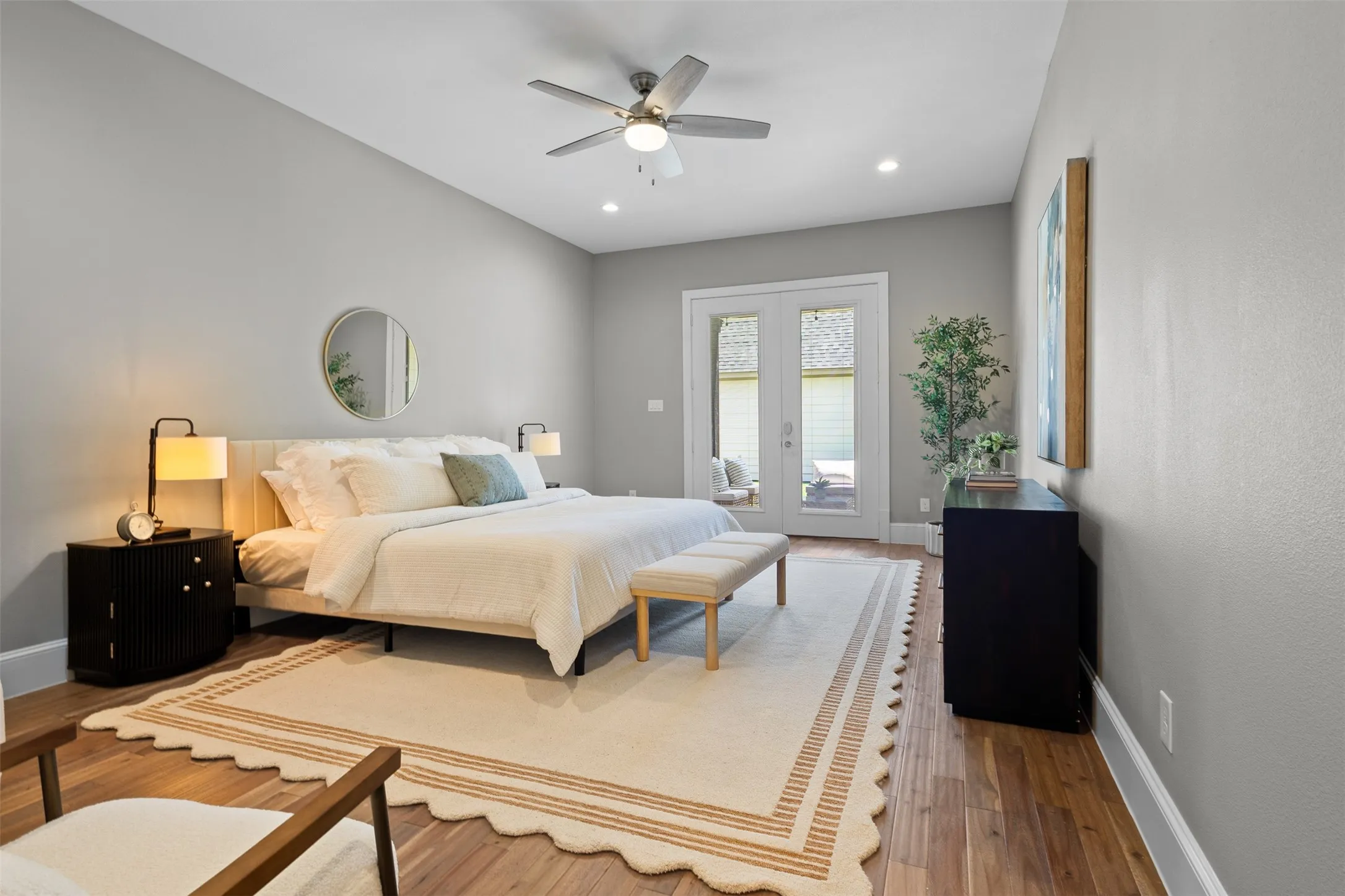 Wood-finish flooring, vaulted ceilings, recessed lighting, and a ceiling fan