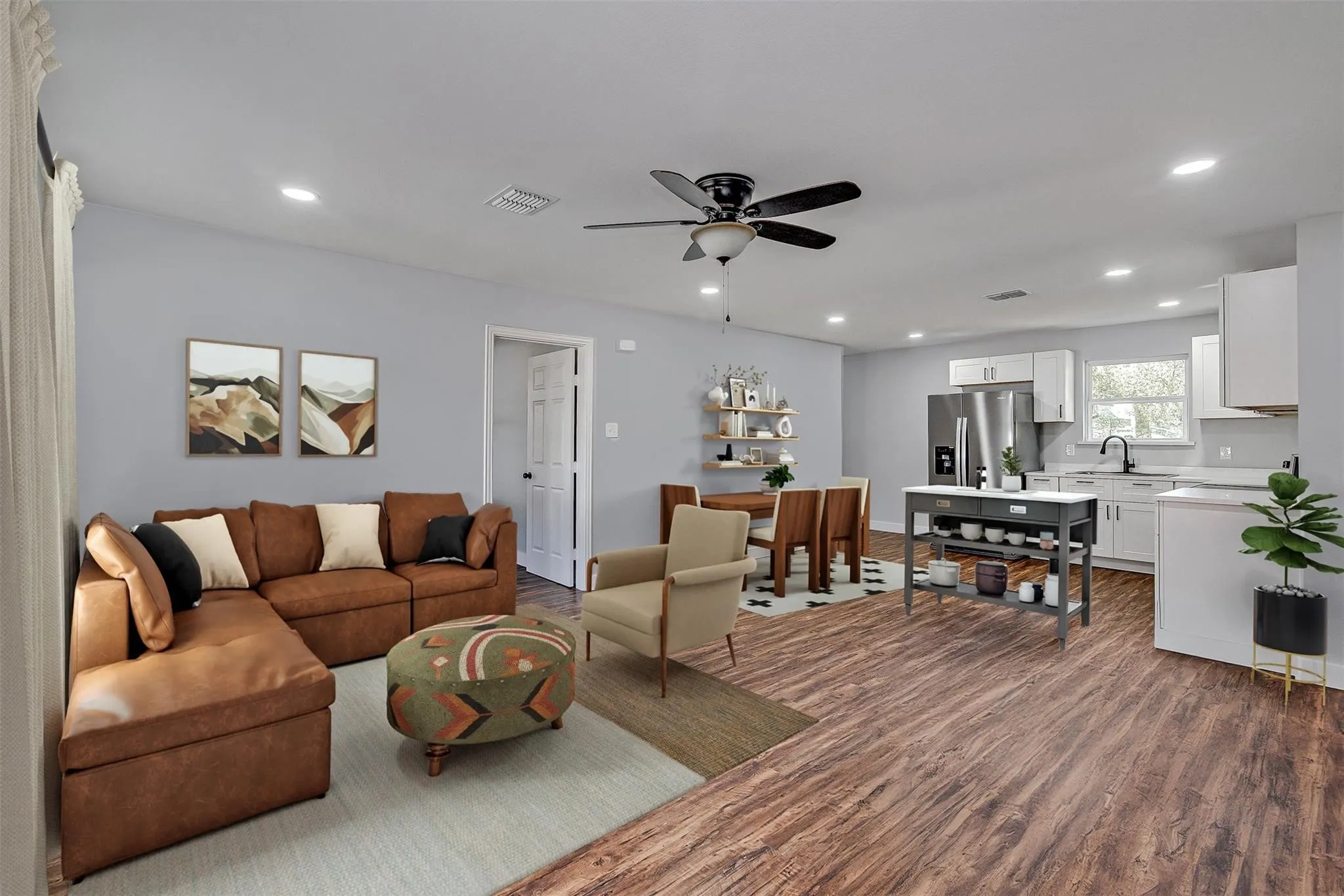 Open-concept living area featuring wood-finish flooring, recessed lighting, and a ceiling fan