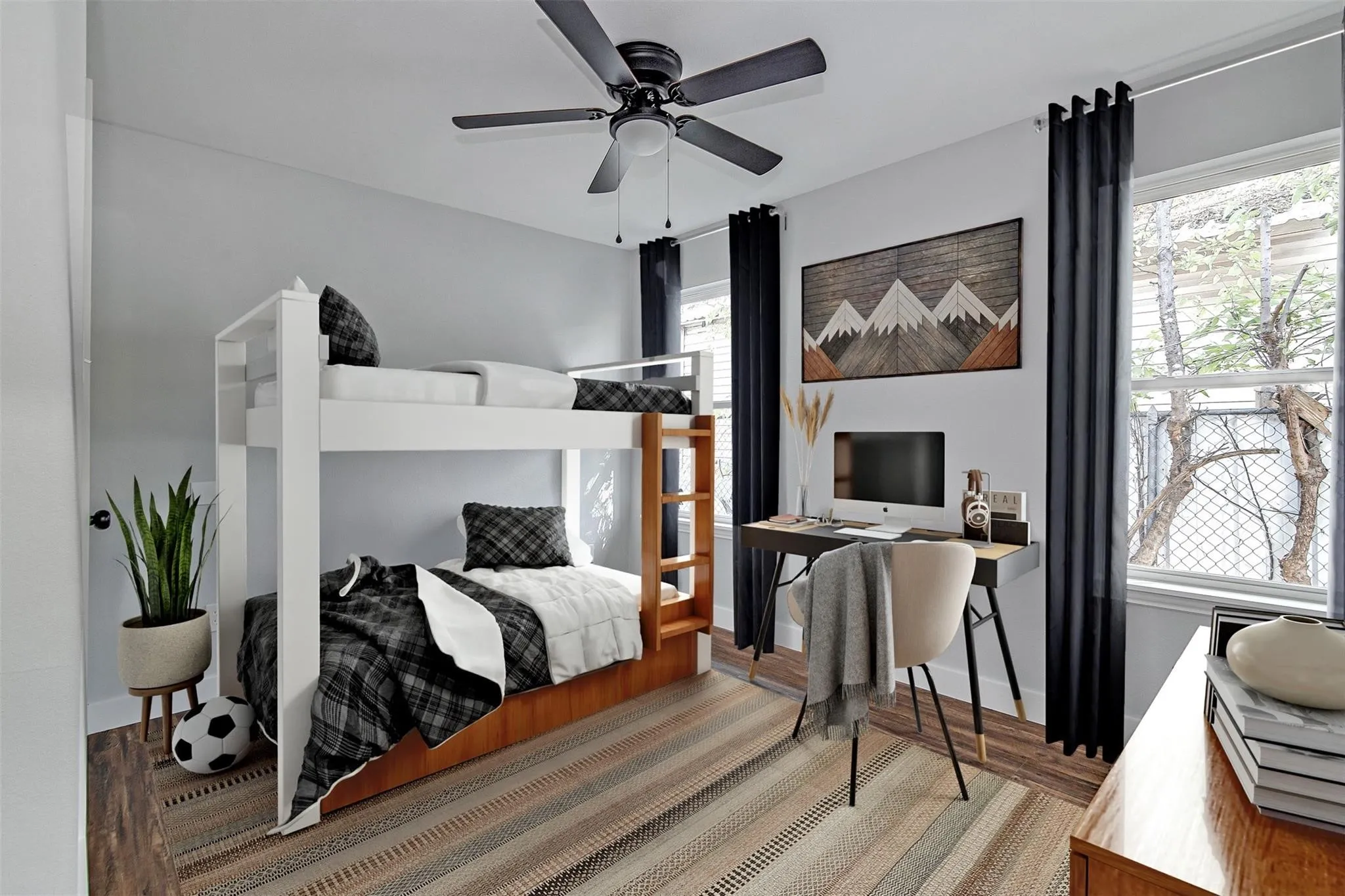 Room featuring wood-finish flooring, two large windows with dark drapery, a ceiling fan, and light-toned walls