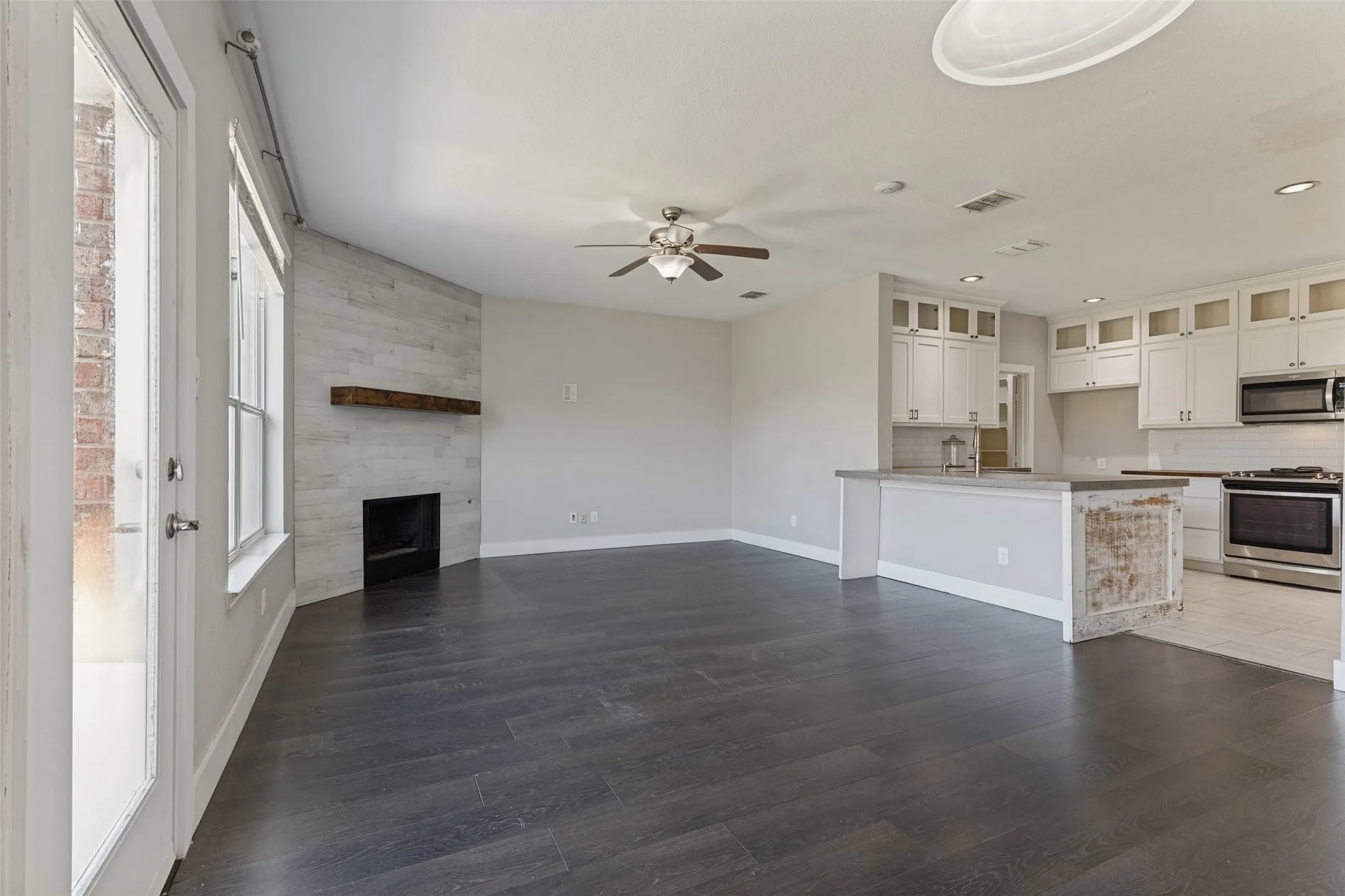 Designer kitchen featuring concrete countertops and custom cabinetry