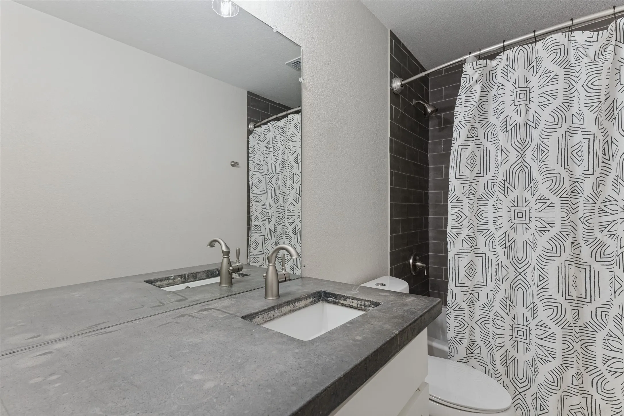 Upstairs bathroom with concrete vanity and shower