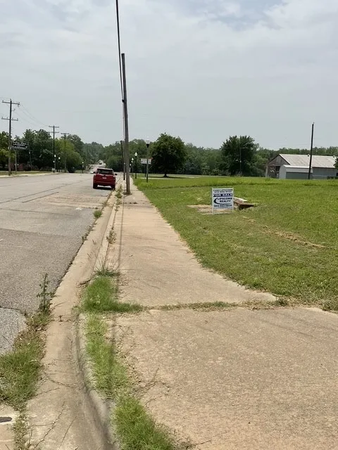 View of asphalt road with sidewalks and curbs