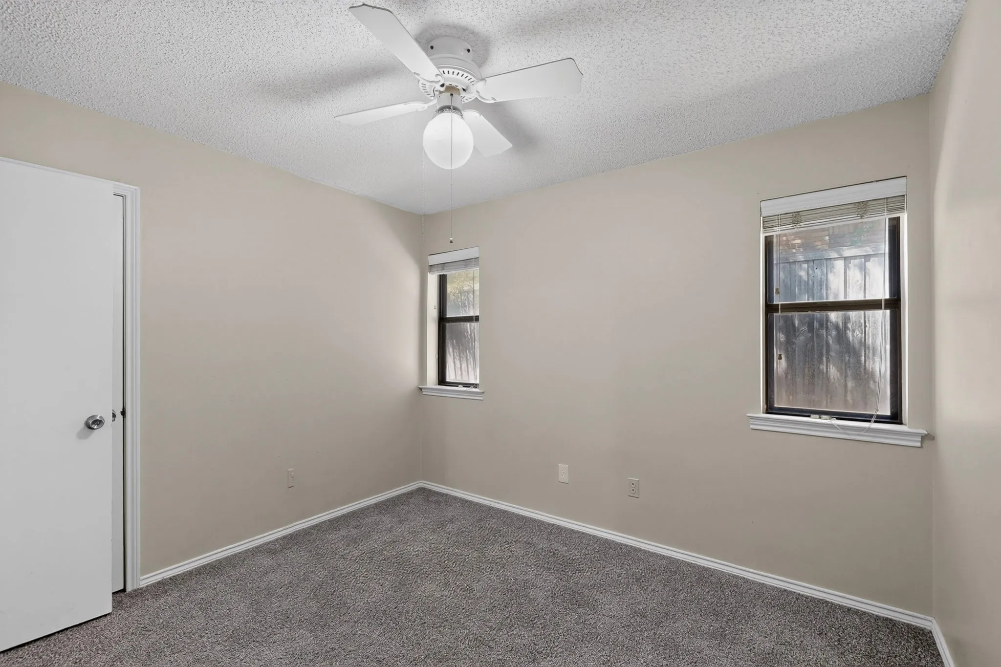 Neutral-toned walls complement plush carpeting