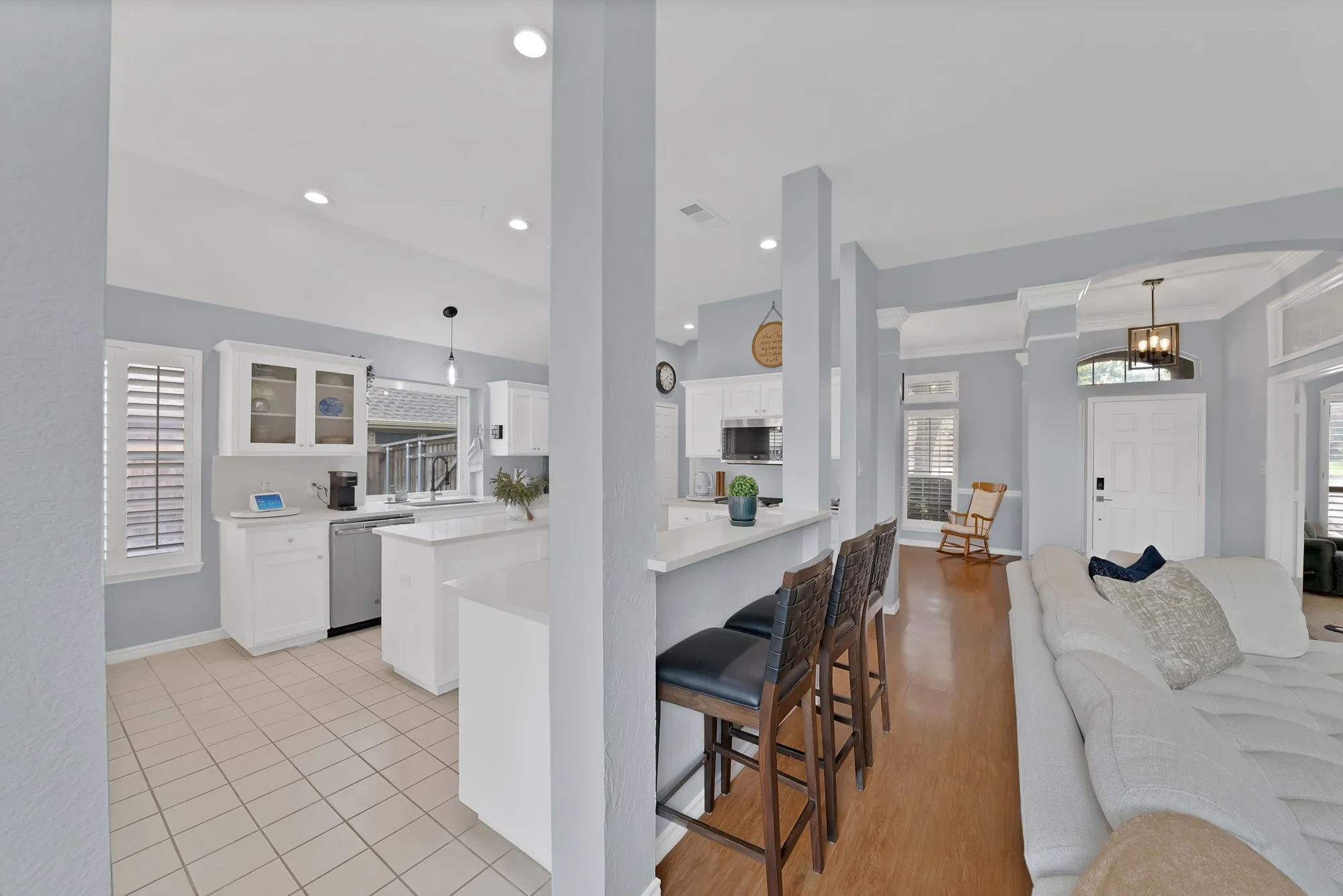Kitchen featuring white cabinetry, tile flooring, recessed lighting, and a breakfast bar