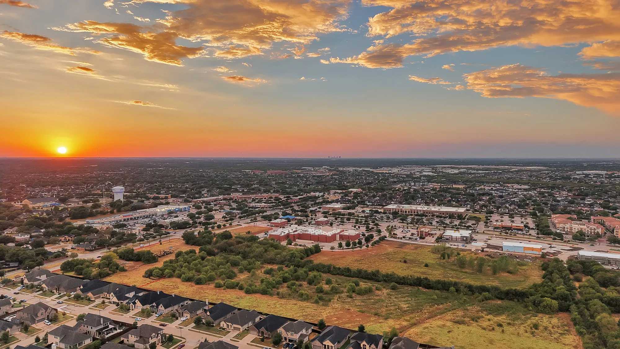 Expansive developed area featuring residential properties, commercial establishments, and open land